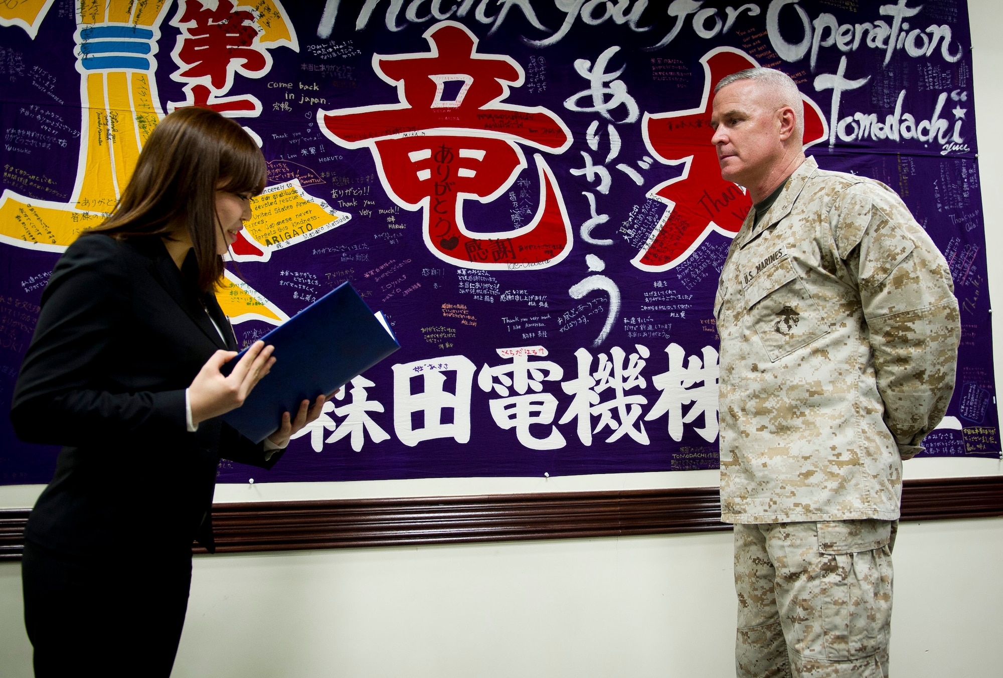 YOKOTA AIR BASE, Japan -- Ikuko Tokuyo Gakushuin Women's College student, presents Brig. Gen. Blake Crowe, United States Forces Japan deputy commander, a certificate she and her students made symbolizing their appreciation for the United States Armed Forces' effort during Operation Tomodachi March 16, 2012. Prior to the ceremony, the students received a tour of the base and a C-130 Hercules, an aircraft that played a vital role during the recovery effort after the tsunami. (U.S. Air Force photo/Staff Sgt. Chad C. Strohmeyer)