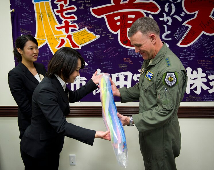 YOKOTA AIR BASE, Japan -- Nao Saito, Gakushuin Women's College student, presents Lt. Gen. Burton Field, United States Forces Japan commander and 5th Air Force commander, 1,000 cranes she and her students made symbolizing their appreciation for the United States Armed Forces' effort during Operation Tomodachi March 16, 2012. The presentation of origami cranes is a Japanese tradition that is believed to grant ones wishes true. (U.S. Air Force photo/Staff Sgt. Chad C. Strohmeyer)