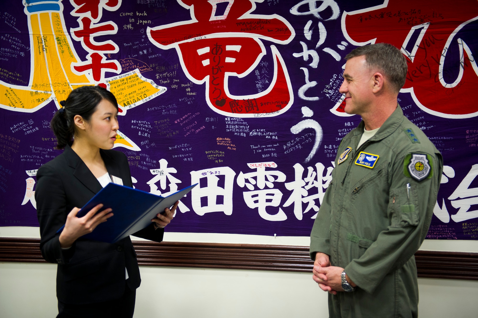 YOKOTA AIR BASE, Japan -- Asuka Noguchi, Gakushuin Women's College student, presents Lt. Gen. Burton Field, United States Forces Japan commander and 5th Air Force commander, a certificate she and her students made symbolizing their appreciation for the United States Armed Forces' effort during Operation Tomodachi March 16, 2012. Prior to the ceremony, the students received a tour of the base and a C-130 Hercules, an aircraft that played a vital role during the recovery effort after the tsunami. (U.S. Air Force photo/Staff Sgt. Chad C. Strohmeyer)