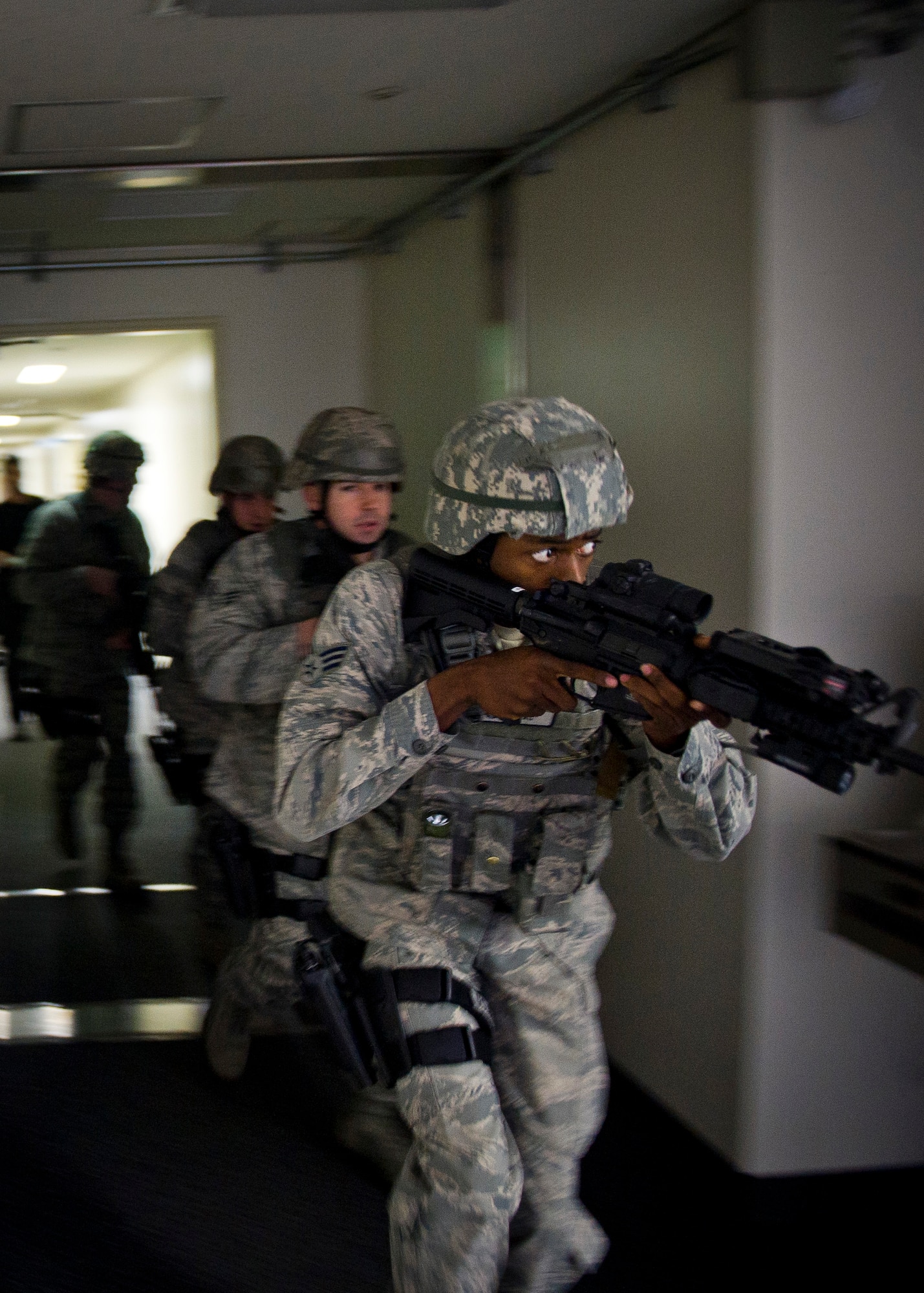 YOKOTA AIR BASE, Japan -- Senior Airman Jermaine Anderson, 374th Security Forces Squadron patrolman, searches the hallways with his team in building 314 in search of a shooter during an active shooter scenario March 15, 2012. Security forces personnel recieve this training annually and is designed to give them the tactics, techniques and procedures to find and neutralize a threat. (U.S. Air Force photo/Staff Sgt. Chad C. Strohmeyer)