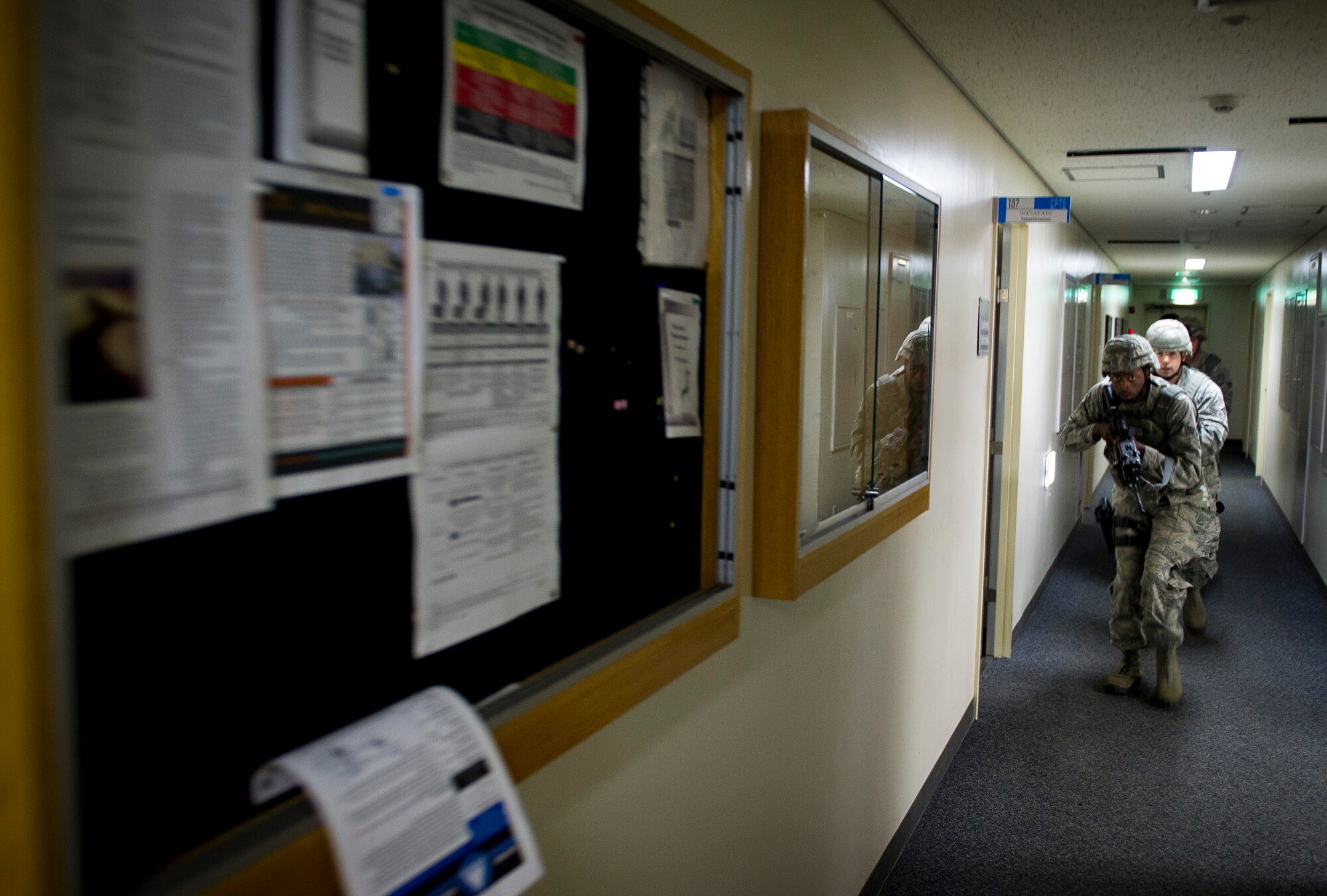 YOKOTA AIR BASE, Japan -- 374th Security Forces Squadron patrolmen, enter building 314 in search of a shooter during an active shooter scenario March 15, 2012. Security forces personnel recieve this training annually and is designed to give them the tactics, techniques and procedures to find and neutralize a threat. (U.S. Air Force photo/Staff Sgt. Chad C. Strohmeyer)