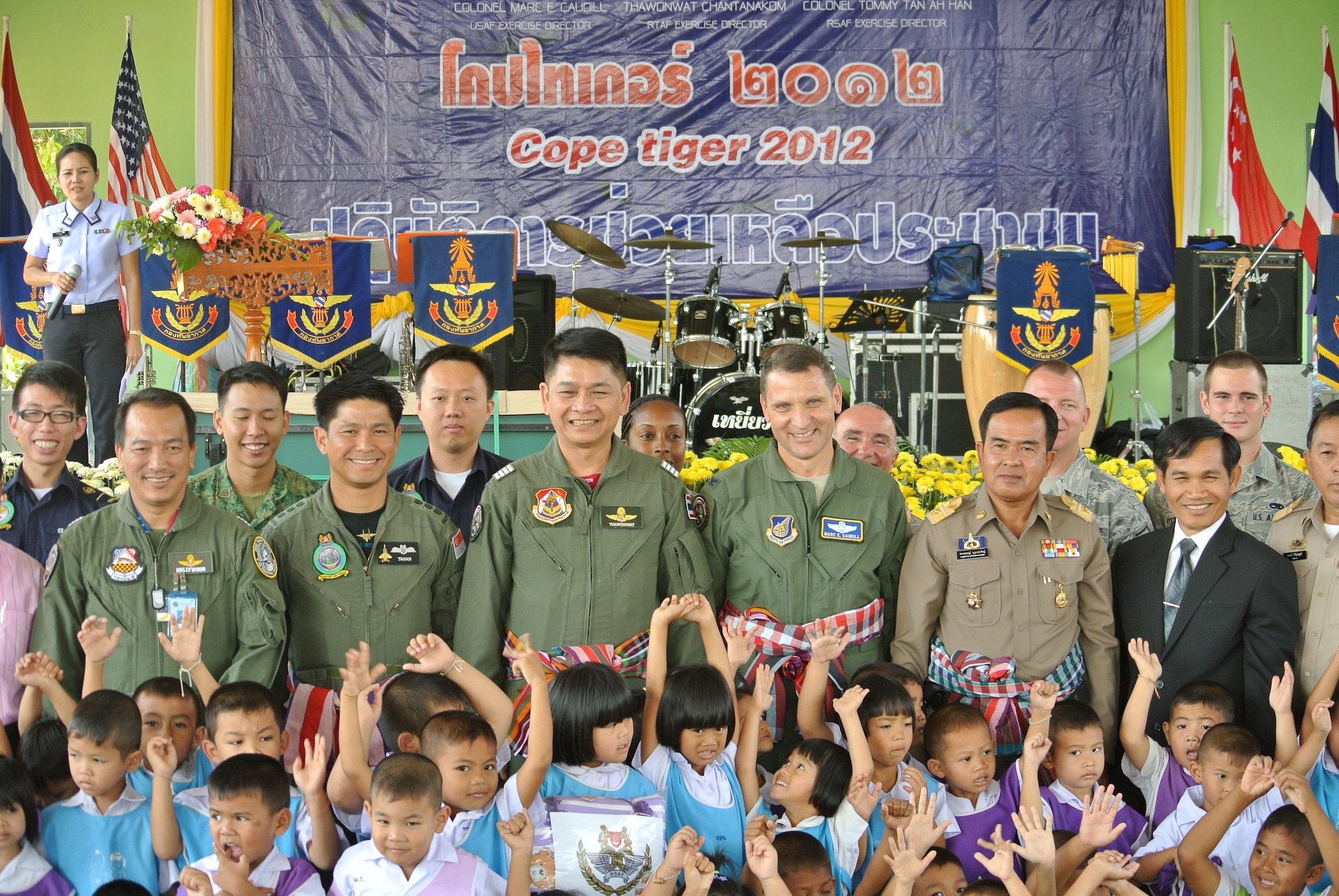 Cope Tiger exercise directors from the U.S. Air Force, Republic of Singapore Air Force and host, Royal Thai Air Force, pose for a group photo with students from the Watprommarat School here during a community outreach and cultural exchange event, Mar. 13. The 269-student school was visited by more than 40-Airmen from the three nations, currently participating in exercise Cope Tiger, a large force air employment exercise designed to enhance readiness and interoperability among participating nations in the Asia-Pacific region. (U.S. Air Force Photo/Capt. David Herndon)