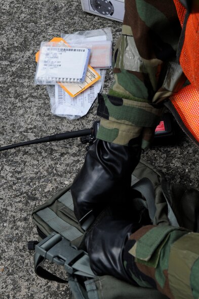 During local operational readiness exercises, Airmen must maintain paperwork for their gas masks and any simulated supplements they are required to take on Kadena Air Base, Japan, March 16, 2012. All paperwork, protective equipment use and scenario procedures can be evaluated at any time during a LORE. (U.S. Air Force photo by Airman 1st Class Tara A. Williamson/Released)