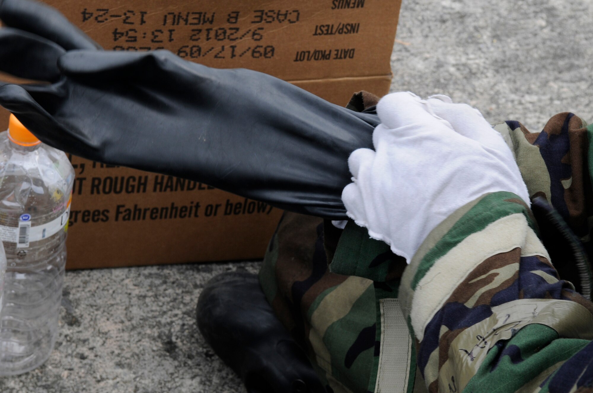 Two glove layers are worn to protect the skin of Airmen participating in local operational readiness exercise Beverly High 12-3 on Kadena Air Base, Japan, March 16, 2012. If skin is open to the air during a chemical attack, Airmen risk contaminating themselves and others. (U.S. Air Force photo by Airman 1st Class Tara A. Williamson/Released)