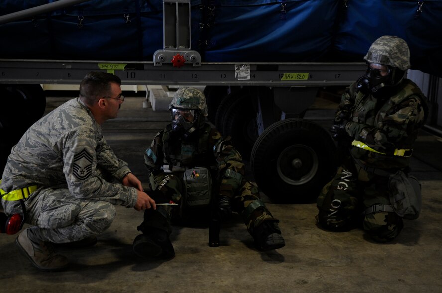 U.S. Air Force Chief Master Sgt. Ed Runkle, an exercise evaluator, reviews the procedures of a scenario with Airmen during local operational readiness exercise Beverly High 12-3 on Kadena Air Base, Japan, March 13, 2012. Procedures are evaluated during LOREs to ensure tasks are done correctly and no one is accidentally injured. (U.S. Air Force photo by Airman 1st Class Tara A. Williamson/Released)