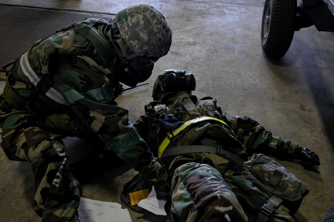 Airmen practice giving chemical antidote injections during a mock nerve agent scenario in local operational readiness exercise Beverly High 12-3 on Kadena Air Base, Japan, March 15, 2012. LORE scenarios help Airmen practice their survival and rescue skills in a safe environment. (U.S. Air Force photo by Airman 1st Class Tara A. Williamson/Released)