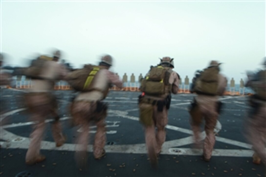 Marines with the 11th Marine Expeditionary Unit's maritime raid force walk toward targets before firing aboard the amphibious transport dock USS New Orleans (LPD 18) on March 9, 2012.  The unit is deployed as part of the Makin Island Amphibious Ready Group, a U.S. Central Command theater reserve force.  The group is providing support for maritime security operations and theater security cooperation efforts in the U.S. Navy's 5th Fleet area of responsibility.  