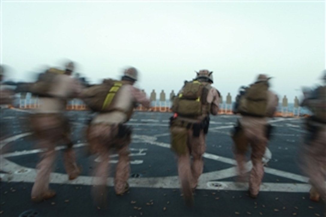 Marines with the 11th Marine Expeditionary Unit's maritime raid force walk toward targets before firing aboard the amphibious transport dock USS New Orleans (LPD 18) on March 9, 2012.  The unit is deployed as part of the Makin Island Amphibious Ready Group, a U.S. Central Command theater reserve force.  The group is providing support for maritime security operations and theater security cooperation efforts in the U.S. Navy's 5th Fleet area of responsibility.  