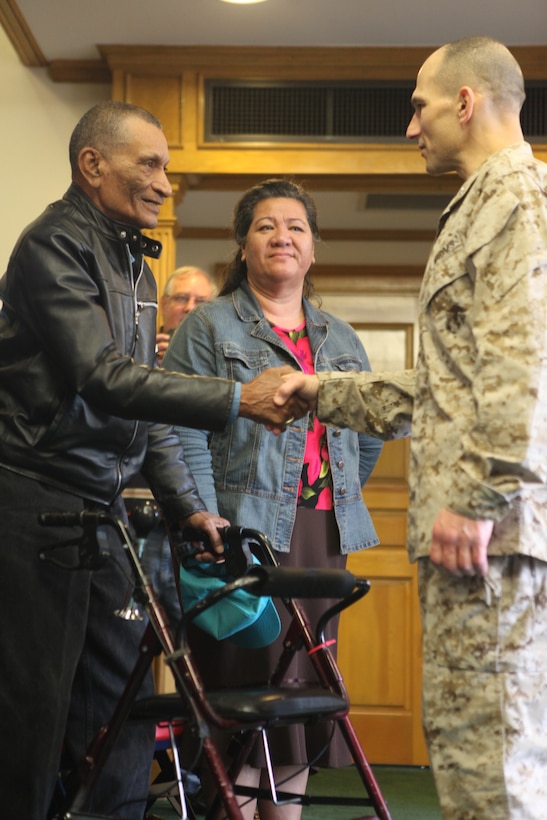 John Crazy Bear, a three-war veteran and retired Marine gunnery sergeant, shakes hands with Brig. Gen. Thomas A. Gorry, commanding general, Marine Corps Installations East, prior to receiving his lost dog tag at a ceremony aboard Marine Corps Base Camp Lejeune, March 17. Gorry thanked those in attendance for sharing the opportunity to return Crazy Bear’s long lost dog tag, a sentiment he appreciated after his time in Afghanistan.