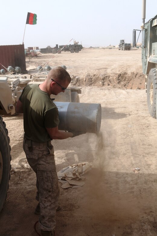 Cpl. Benjamin Sexe, a military policeman and driver with General Support Motor Transport Company, Marine Air-Ground Task Force Support Battalion 11.2, 1st Marine Logistics Group (Forward) cleans an air filter following a mission at Forward Operating Base Edinburgh, March 17. The GSMT Co. Marines perform vehicle maintenance, vehicle operations and heavy equipment operations for their battalion and other units in the area. Additionally, the company is also responsible for escorting Afghan truck drivers carrying fuel to forward operating bases throughout Helmand province.