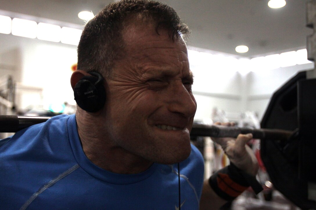 Abe Roman, a retired master sergeant and avid powerlifter, grunts and pushes through a squat repetition with 315 pounds at the IronWorks Gym here March 17. The March 29, 1985, edition of the Torii Teller featured Roman, then as a powerlifter. Roman attributes his success to a number of factors, including the nutritional advice of his wife, Barbara, and being around individuals who share his love of powerlifting.