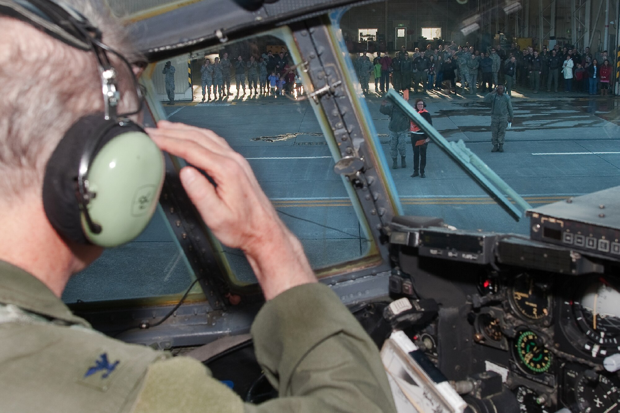 YOKOTA AIR BASE, Japan -- Col. Otto Feather, 374th Airlift Wing commander, salutes his wife, Nancy Feather, after his final flight March 15, 2012 of a C-130 Hercules at Yokota Air Base, Japan. Known as the "fini flight," military aviators have a tradition where after completion of their final flight, aircrew members are met and hosed down with water by their squadron comrades, family and friends. (U.S. Air Force photo/Osakabe Yasuo)