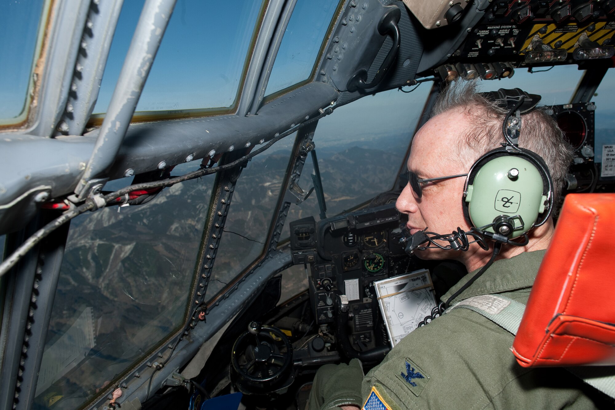 OVER KANTO PLAIN, Japan -- Col. Otto Feather admires the view of the Kanto Plains during his final flight March 15, 2012 from the window of a C-130 Hercules. Known as the "fini flight," military aviators have a tradition where after completion of their final flight, aircrew members are met and hosed down with water by their squadron comrades, family and friends. (U.S. Air Force photo/Osakabe Yasuo)