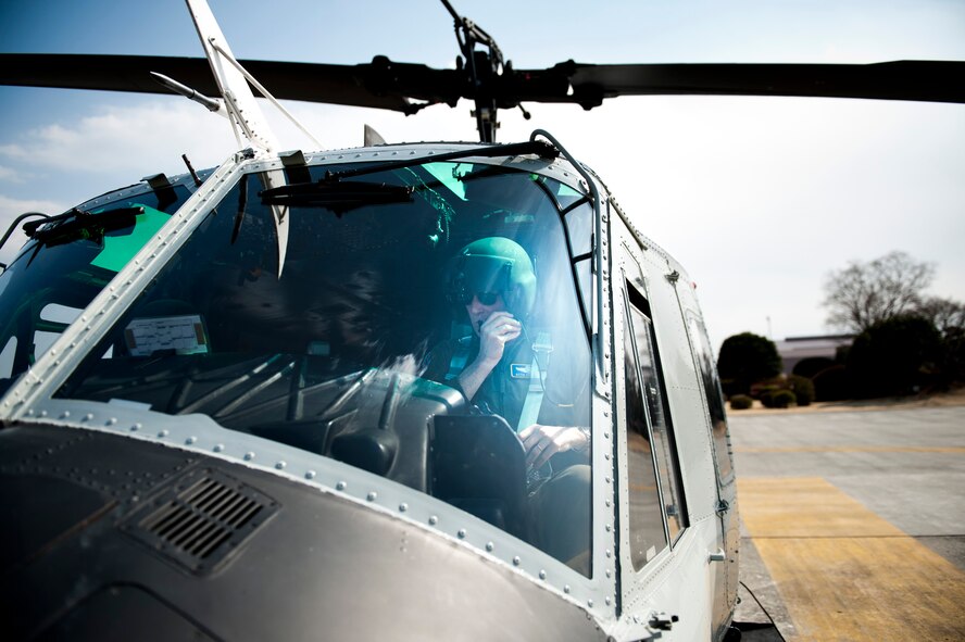 YOKOTA AIR BASE, Japan -- Col. Otto Feather, 374th Airlift Wing commander, checks his communications systems in a UH-1N Iroquois at Yokota Air Base, Japan, March 15, 2012. Feather made his final flights in each of the wing's three airframes during that day. (U.S. Air Force photo/Staff Sgt. Samuel Morse)