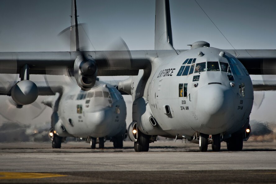 YOKOTA AIR BASE, Japan -- Two C-130 Hercules prepare for takeoff at Yokota Air Base, Japan, March 15, 2012. C-130s provide critical intra-theater airlift capabilities and can land on a variety of less-than-ideal surfaces such as dirt runways. (U.S. Air Force photo/Staff Sgt. Samuel Morse)