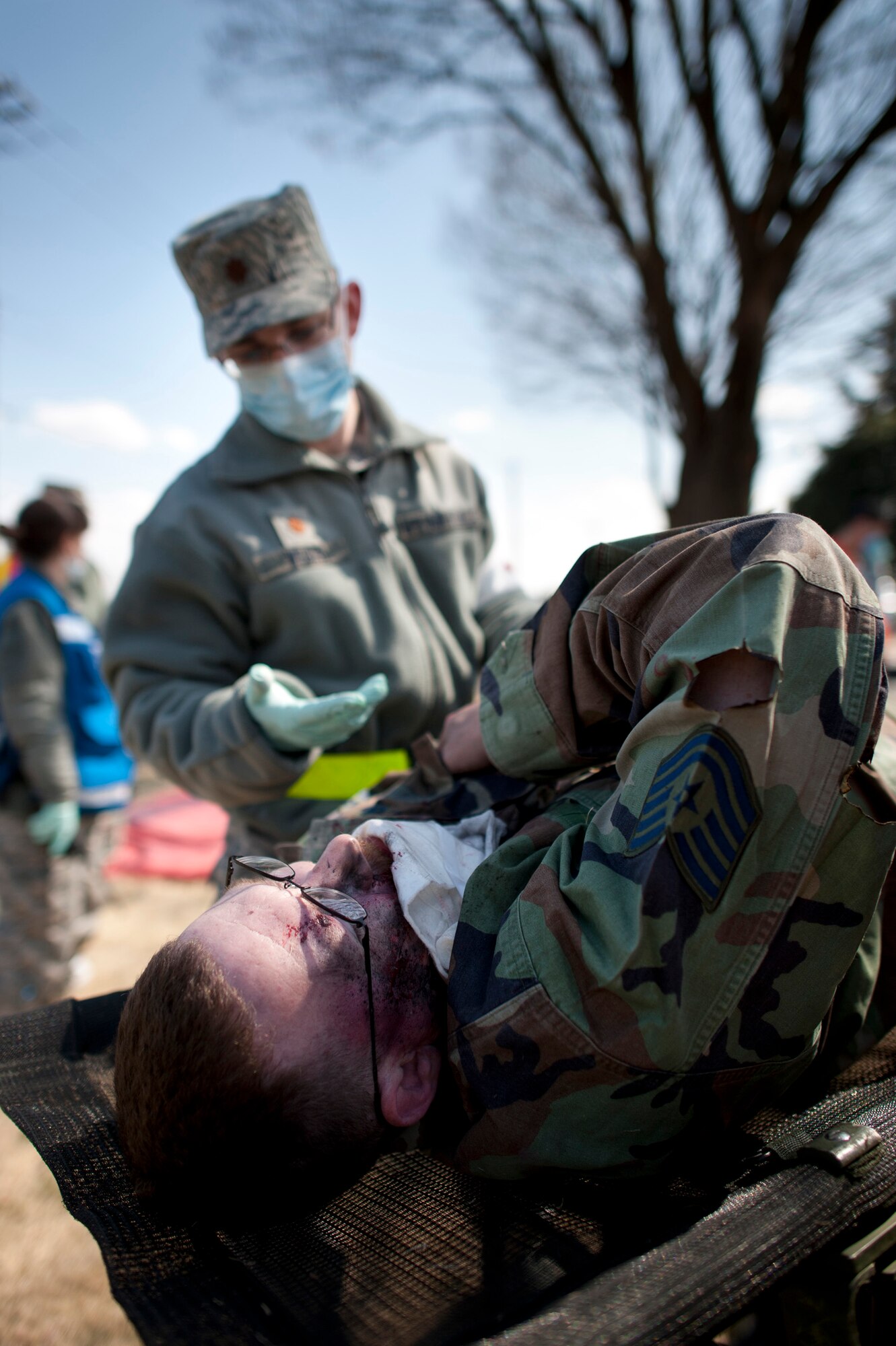 YOKOTA AIR BASE, Japan -- A simulated victim clutches his shoulder during an emergency management exercise at Yokota Air Base, Japan, March 14, 2012. The 374th Airlift Wing held the EME to test and train its Airmen to respond to emergencies quickly and effectively. (U.S. Air Force photo/Staff Sgt. Samuel Morse)