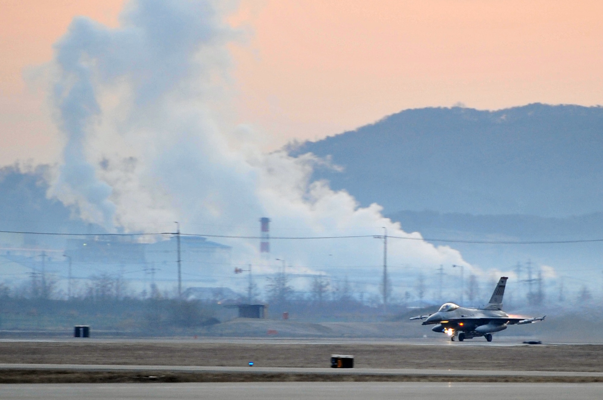 The first F-16 Fighting Falcon sortie for operational readiness exercise Beverly Midnight 12-01 prepares for launch on Osan Air Base’s runway, March 20, 2012. Team Osan Airmen are in the second week-long simulated wartime contingency exercise executed in 2012 that will test the base’s ability to defend and execute the mission in a heightened state of readiness. (U.S. Air Force photo/Staff Sgt. Craig R. Cisek)