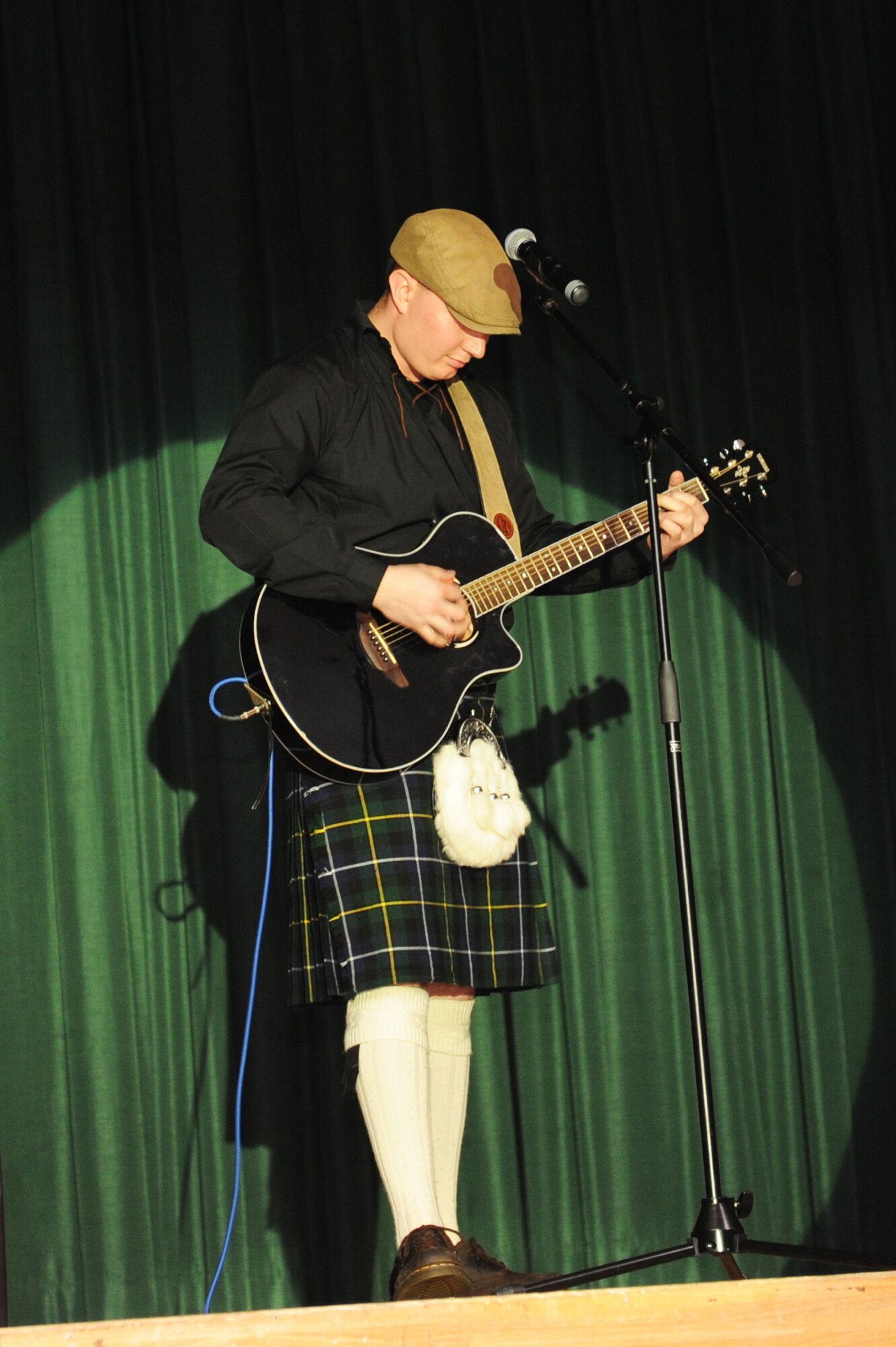 Charles Johnson, Misawa Solo Star contestant, performs his rendition of "The Wild Rover" during the Misawa Solo Star singing competition finale at Misawa Air Base, Japan, March 17, 2012. The contestants were judged on two song choices. One song was the judges' choice and the other song was chosen by the contestant. Nereza Lam, not pictured, won the contest, earning her the $1,000 prize. (U.S. Air Force photo by Airman 1st Class Kia Atkins/Released)