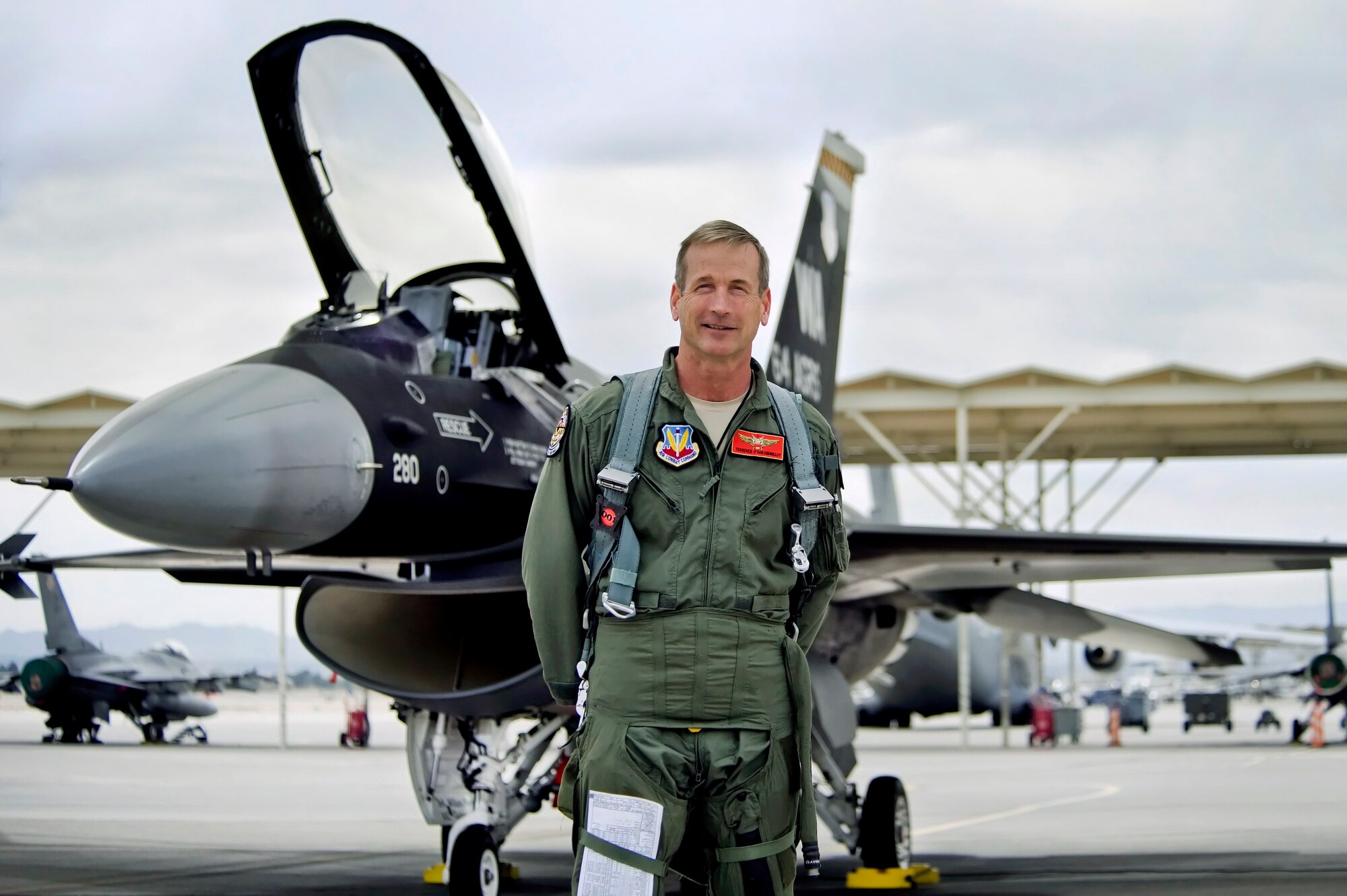 U.S. Air Force Brig. Gen. Terrence O'Shaughnessy, 57th Wing commander, poses in front of his F-16 Fighter Falcon prior to his final flight as wing commander March 16, 2012 at Nellis Air Force Base, Nev. O'Shaughnessy will relinquish command to Brig. Gen. Charles L. Moore during a change of command ceremony at 10:57 a.m. March 26. (U.S. Air Force photo by Lawrence Crespo)
