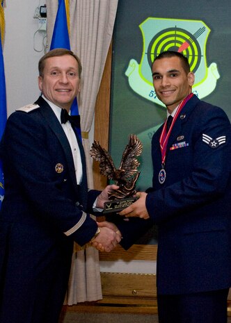 Brig. Gen. David Buck, left, USAF Warfare Center vice commander, presents the John Levitow Award to Senior Airman Jonathan McConico, center, from the 757th Maintenance Squadron Feb. 23rd, 2012 at the Nellis Airman Leadership School graduation ceremony at Nellis Air Force Base, Nev. The Levitow Award is the highest award in Air Force enlisted professional military education and recognizes the top ALS student in each class, both for academic excellence and demonstrated military leadership. (U.S. Air Force photo by Airman 1st Class Matthew Lancaster)