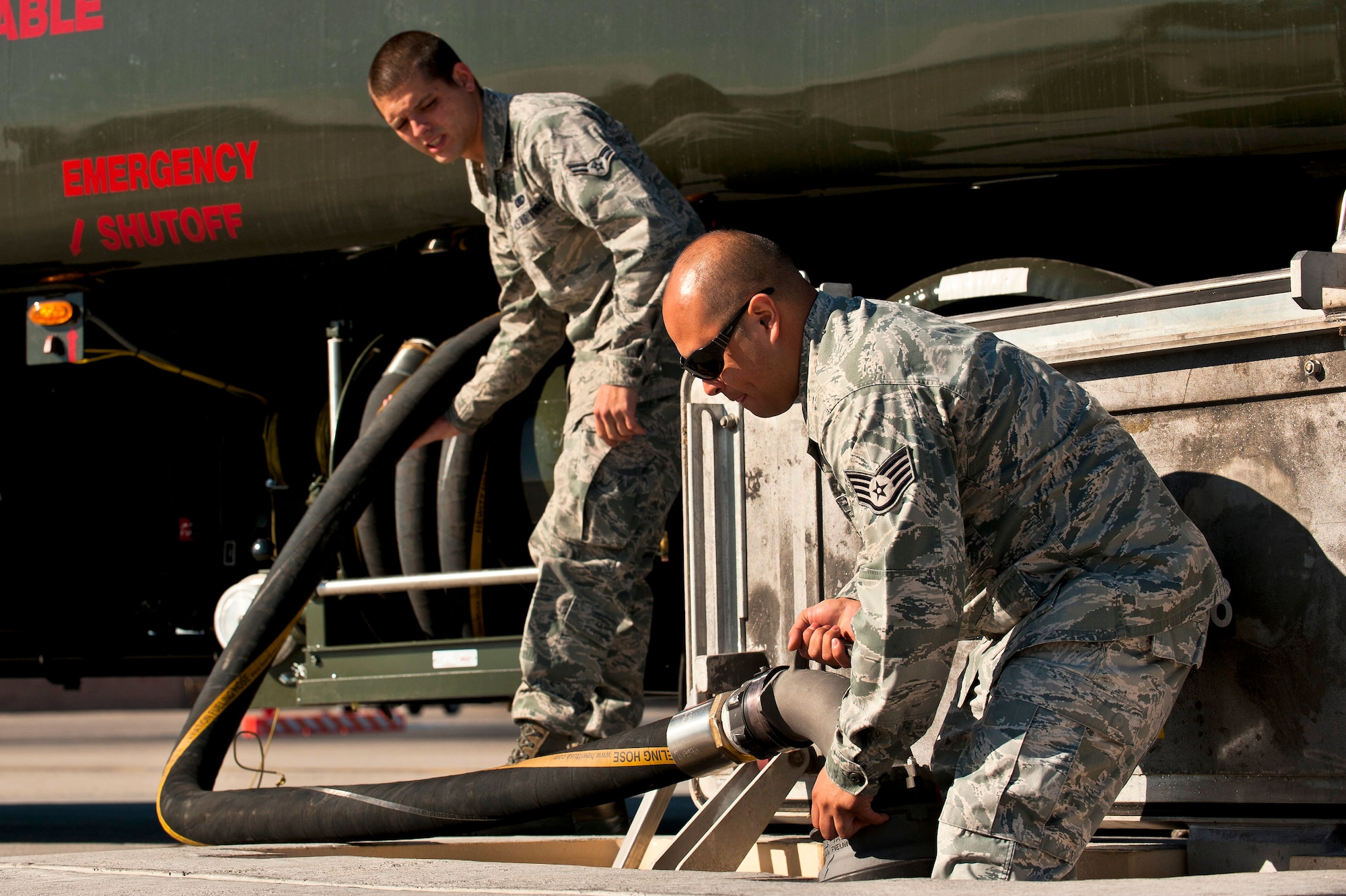 Staff Sgt. Carlos Fuentes, 99th Logistics Readiness Squadron refueling maintenance craftsman, and Airman 1st Class Tyler Fontaine, 99 LRS refueling maintenance journeyman, connect a fuel hose between the hydrant fuel system and an R-11 fuel tanker truck, March 19, 2012 at Nellis Air Force Base, Nev. The Hydrant Mobile Refueler system, or HYMORE, was installed on two of Nellis' R-11s for testing. The system should save the Air Force millions of dollars. (U.S. Air Force photo by Senior Airman Brett Clashman)