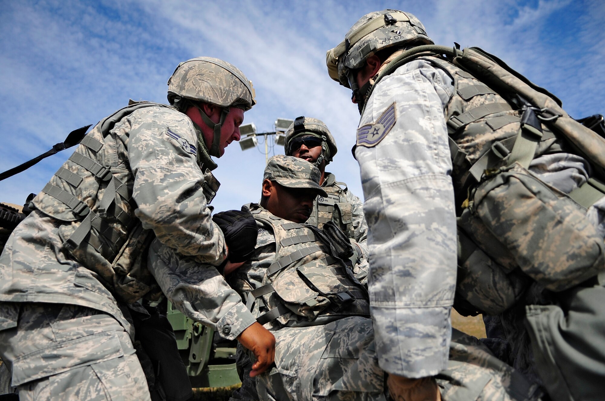 VANDENBERG AIR FORCE BASE, Calif. -- Team V members help carry a wounded Airman to safety during a simulated attack at the Northstar exercise here Thursday, March 15, 2012. The Northstar exercise tests the deployment capabilities and combat readiness skills for Vandenberg Airmen. (U.S. Air Force photo/Michael Peterson)