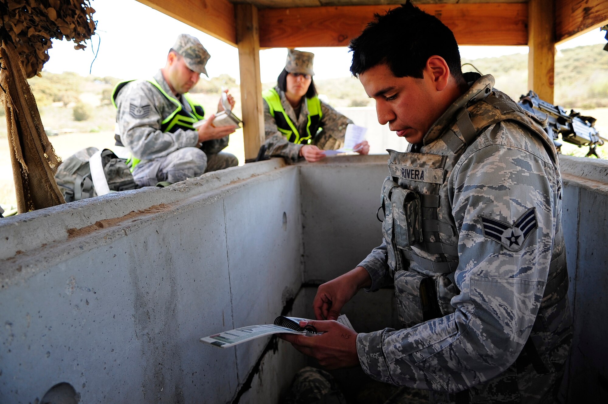 VANDENBERG AIR FORCE BASE, Calif. -- Senior Airman Joseph Rivera, 30th Security Forces Squadron member, reviews his Airman's manual for Self-Aid and Buddy Care information here Thursday, March 15, 2012. The Northstar exercise tests the deployment capabilities and combat readiness skills for Vandenberg Airmen (U.S. Air Force photo/Michael Peterson)