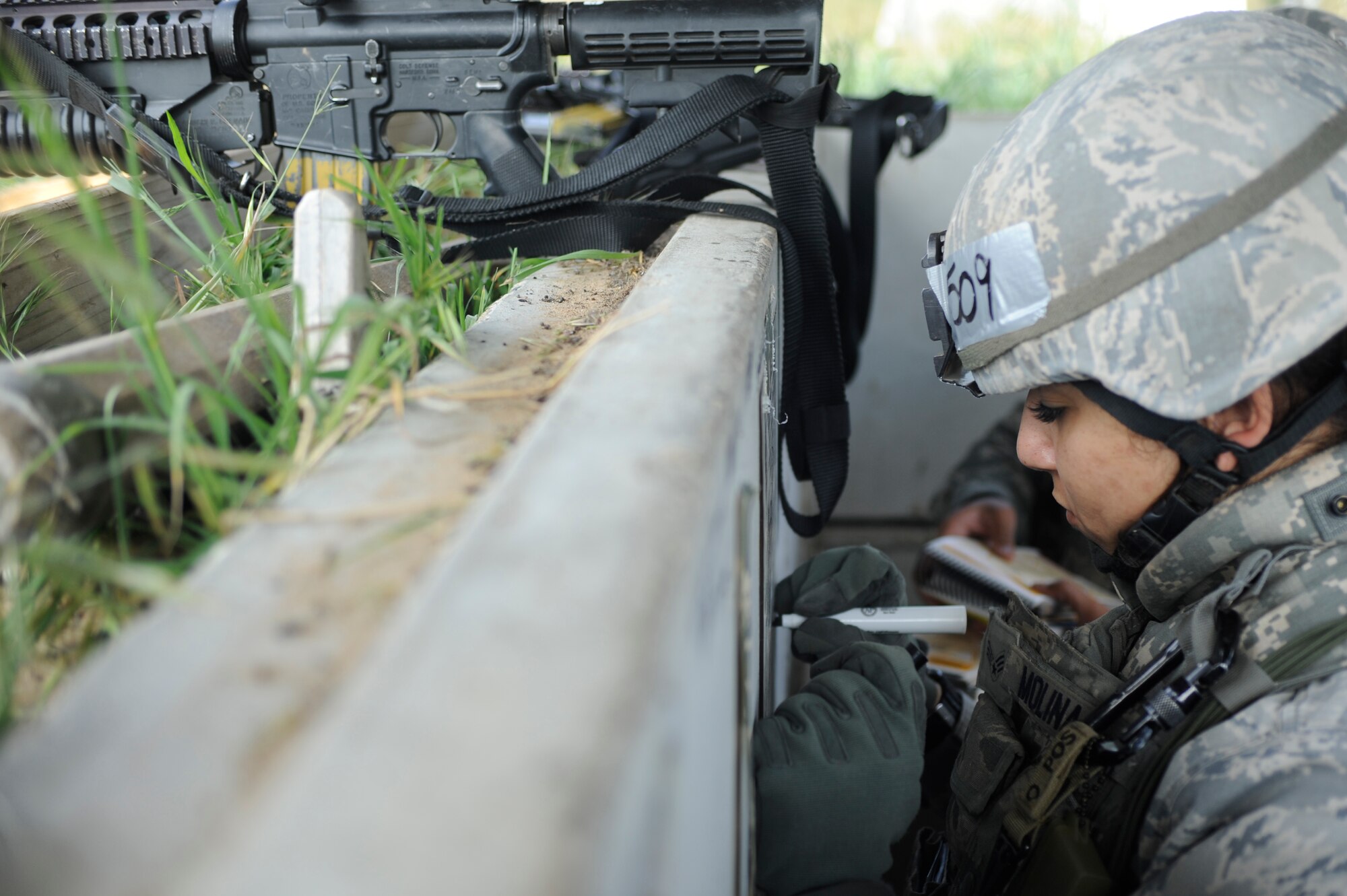 VANDENBERG AIR FORCE BASE, Calif. -- Senior Airman Janette Molina, 30th Security Forces Squadron member, marks locations in a defensive fighting position during the Northstar exercise training here Tuesday, March 13, 2012. The Northstar exercise tests deployment capabilities and combat readiness skills for Airmen. (U.S. Air Force photo/Staff Sgt. Andrew Satran) 



 