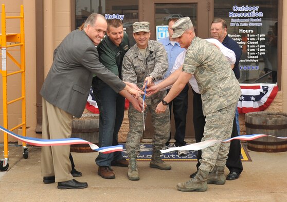 U.S. Air Force Brig Gen. Donald Bacon, 55th Wing commander Offutt Air Force participates in the official ribbon cutting of the outdoor Rec / Auto Hobby Shop Base, on Offutt Air Force Base, Neb., March 15. Bacon was taken on a tour of the facility afterwords while patrons were treated to hot dogs, chips and snacks. A bounce house, dunk tank and prizes were given out to celebrate the event.(Photo by Jeff Gates/Released)