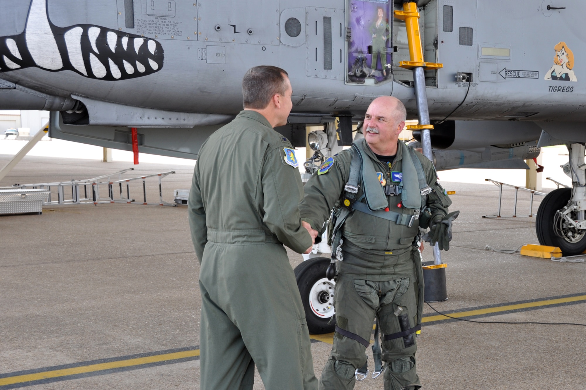 U.S. Air Force Col. John Breazeale, commander of the 917th Fighter Group, congratulates Lt. Col. David Deaton, a pilot assigned to the 47th Fighter Squadron, after returning from a sortie at Barksdale Air Force Base, La., March 15, 2012. This sortie marked the last flight for Deaton before retiring from the Air Force. (U.S. Air Force photo by Master Sgt. Jeff Walston/Released)