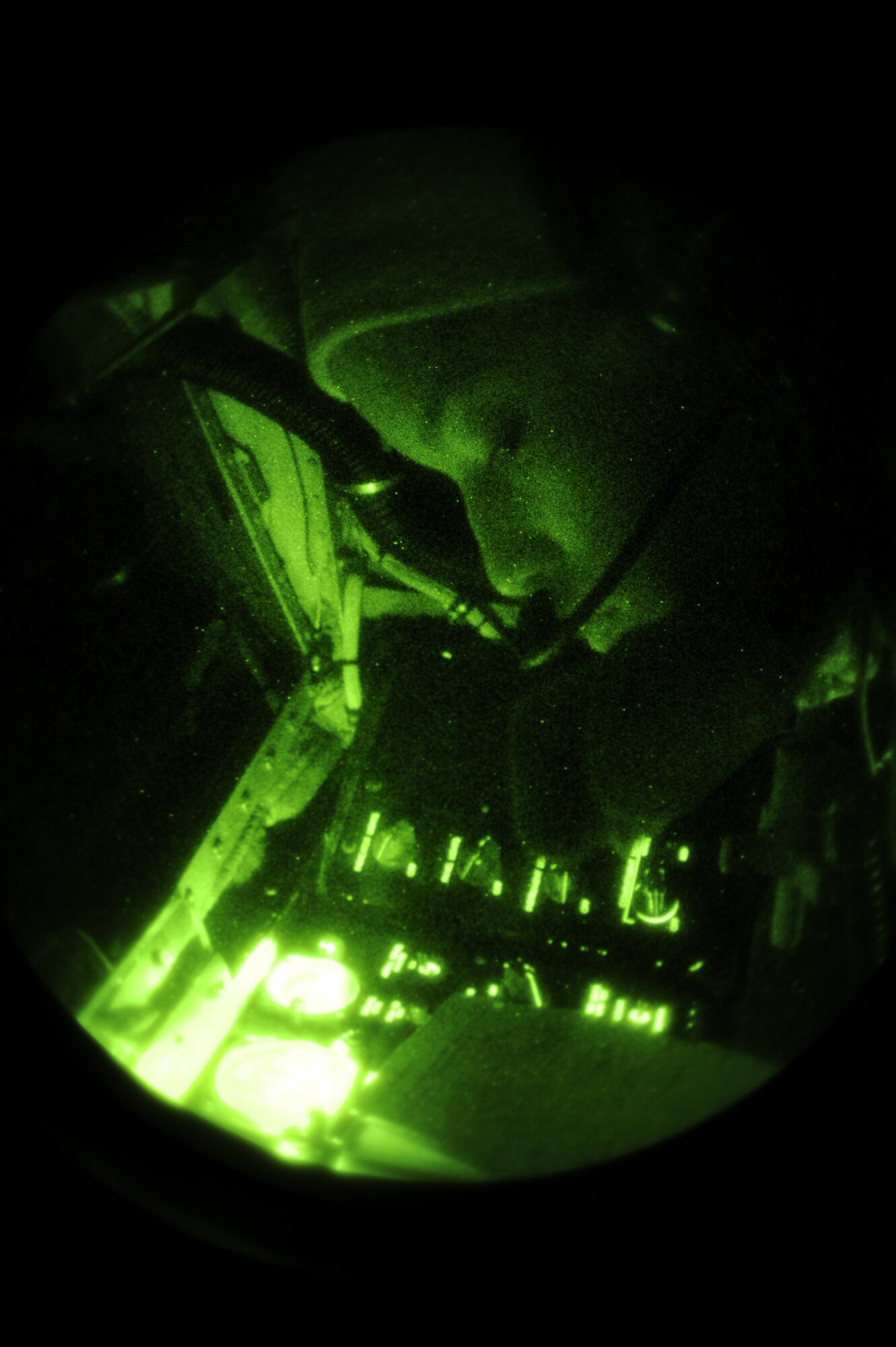 In-flight refueling is demonstrated as Senior Airman Liahna Childs, boom operator, 334th Air Refueling Squadron, pays close attention as she positions a boom into a C-17 Globemaster III for refueling. Childs, who is new at McConnell, says night refueling can be challenging because of difficulty to see the receiving aircraft, but equipment such as night-vision goggles makes it possible. (U.S. Air Force photo by Airman 1st Class Ryan Zeski) 