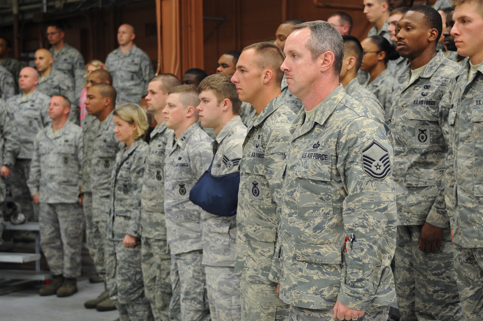 Members of the 820th Base Defense Group stand at attention for the playing of the national anthem during the squadron’s  15-year anniversary at Moody Air Force Base, Ga., March 16, 2012. The 820th BDG was established March 17, 1997 at Lackland Air Force Base, Texas. (U.S. Air Force photo by Airman 1st Class Olivia Dominique/Released)