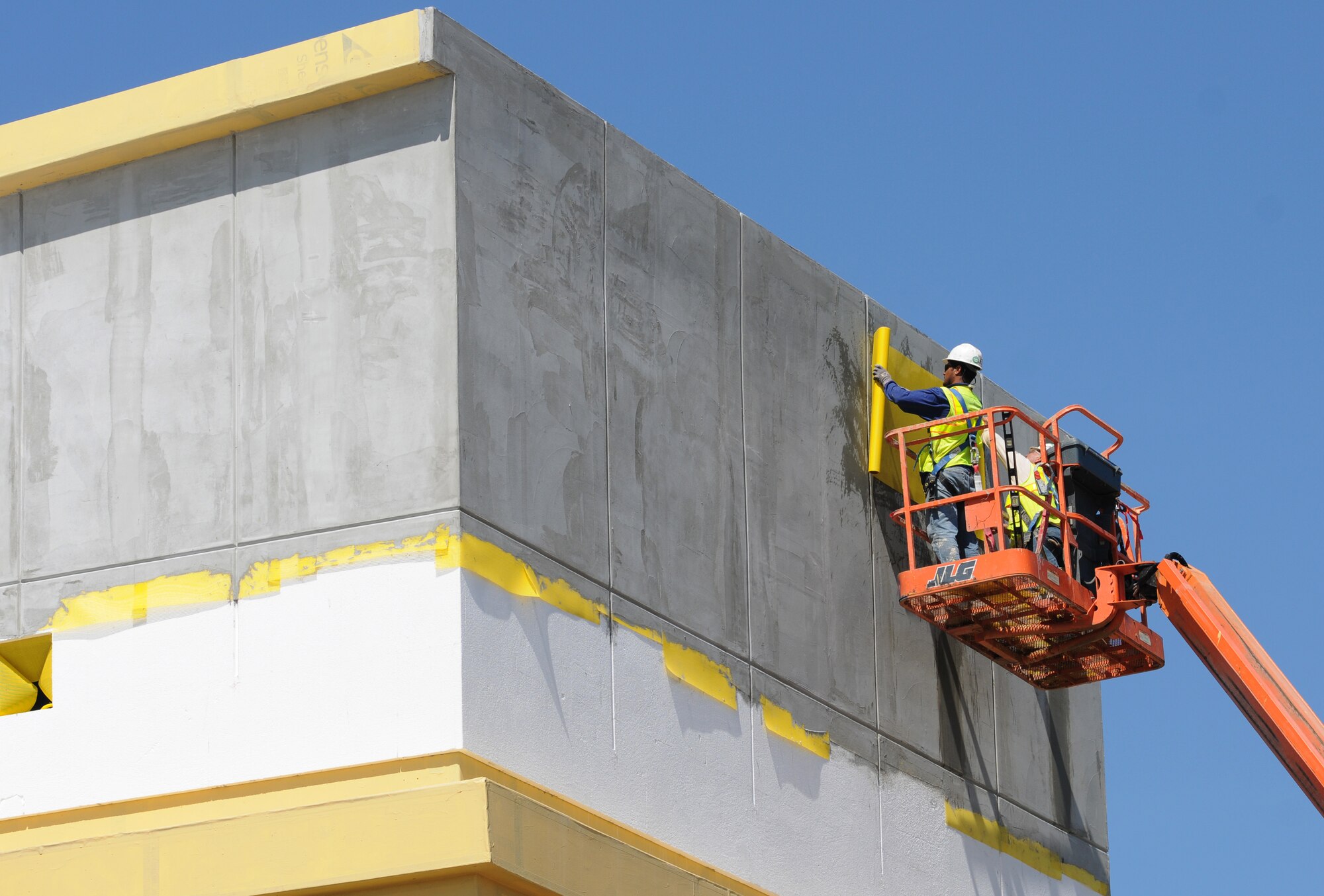 Victor Garcia, Southern Stucco, Inc., applies exterior insulation finish system on the drying tower of the aerial port facility March 15, 2012, at Keesler Air Force Base, Miss.  The drying tower is where parachutes and cargo chutes are hung to dry.  The aerial port facility will be owned and operated by the 403rd Wing.  The facility will be used to support C-130J Hercules operations, training and mobilization requirements.  (U.S. Air Force photo by Kemberly Groue)