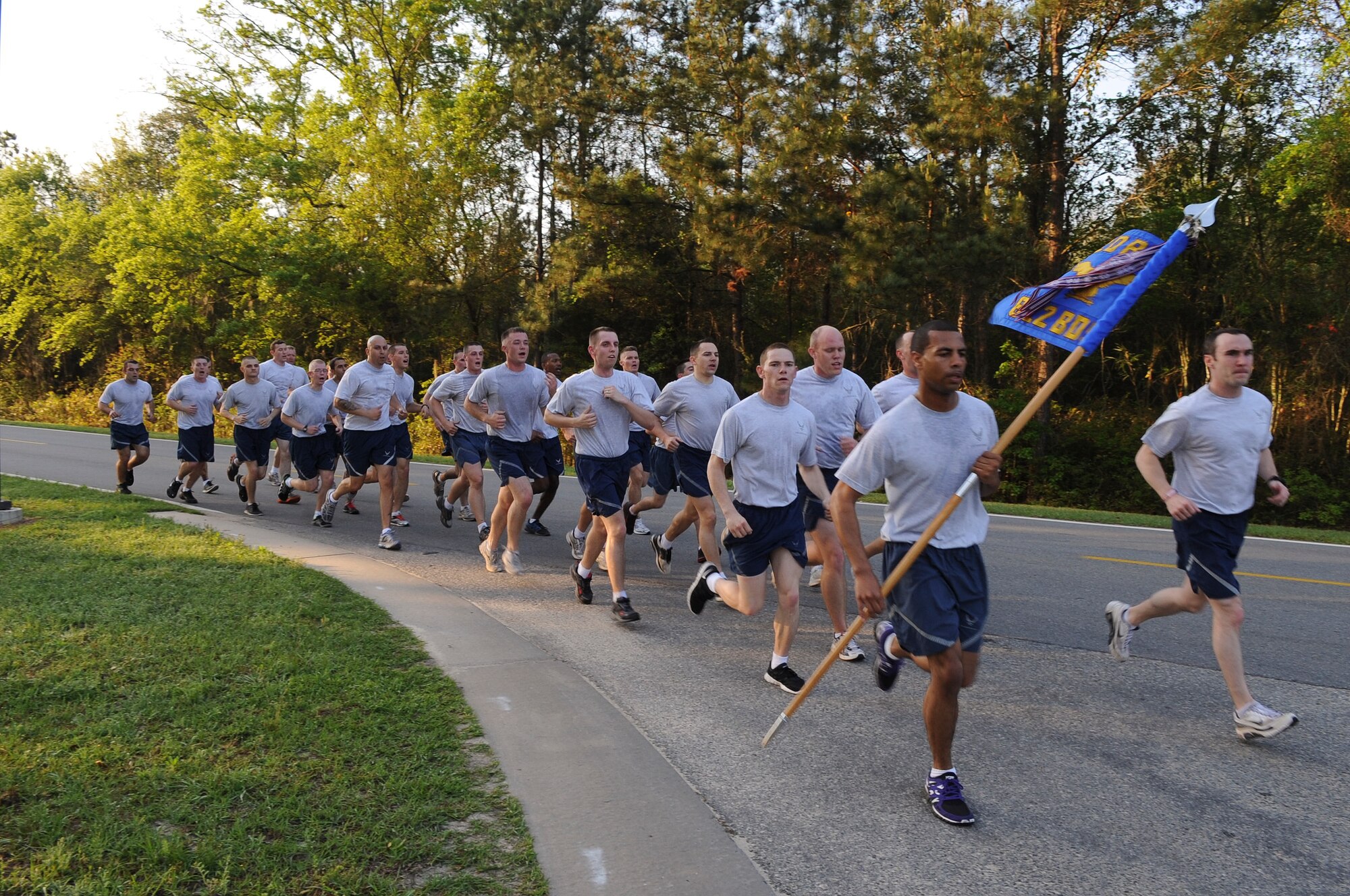 Members of the 820th Base Defense Group finish a 5k run during “Sergeant Rock” physical training to celebrate its 15-year anniversary at Moody Air Force Base, Ga., March 16, 2012. Throughout the session, Airmen were motivated to keep a positive attitude and morale high. (U.S. Air Force photo by Airman 1st Class Olivia Dominique/Released)