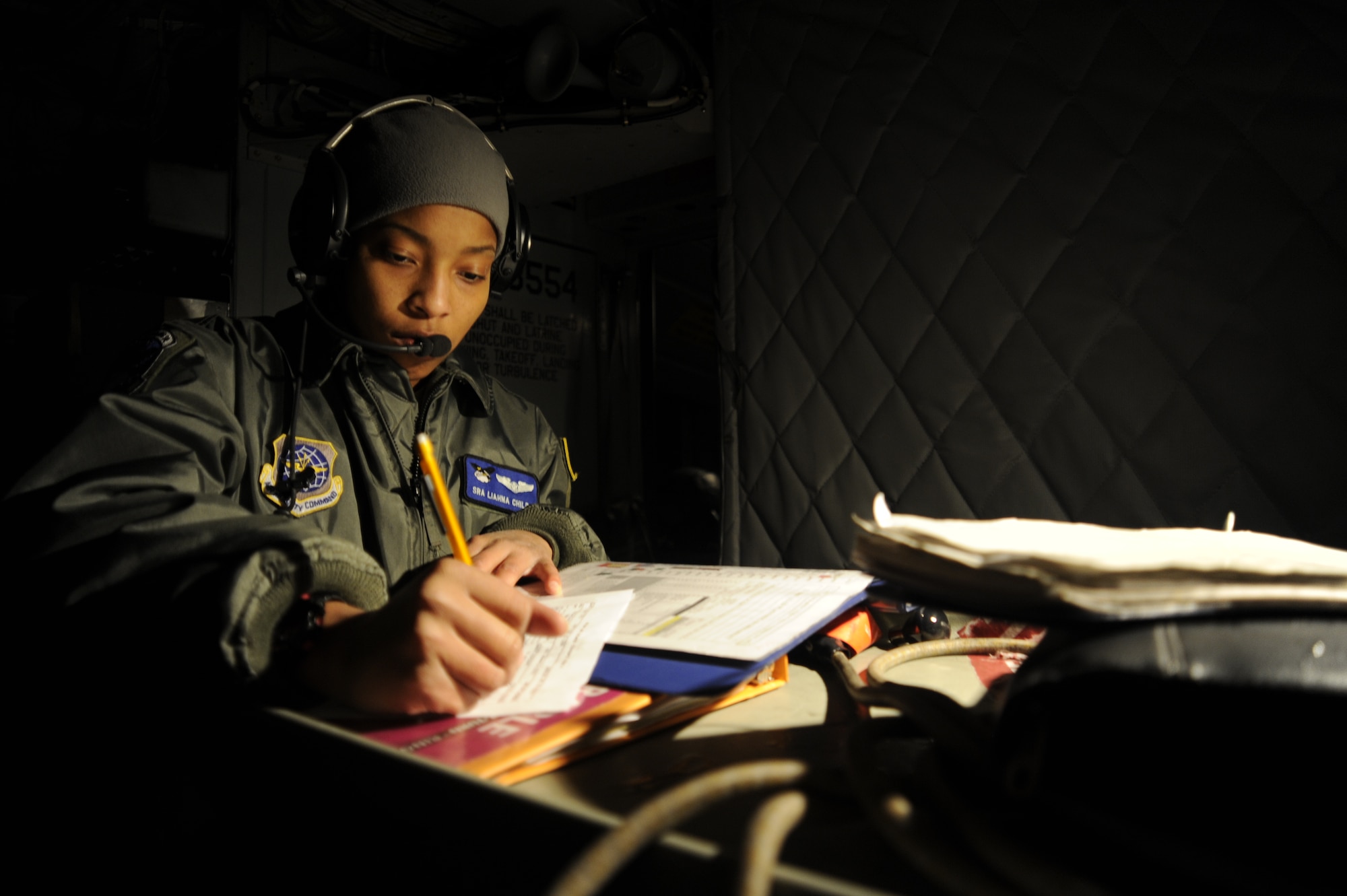 Senior Airman Liahna Childs, boom operator, 334th Air Refueling Squadron, fills out pre-flight paperwork inside a McConnell Air Force Base KC-135 at Fairchild AFB, Wash., March 15, 2012 before takeoff. (U.S. Air Force photo by Airman 1st Class Ryan Zeski)