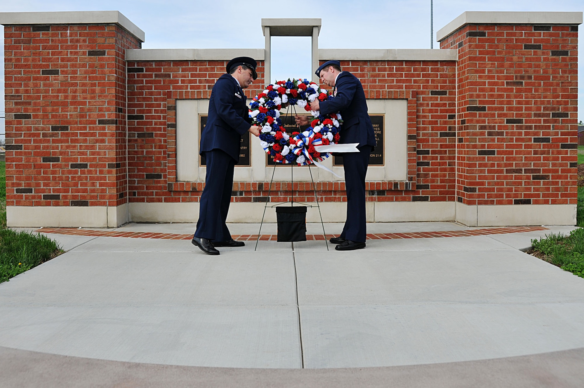 Col. Pete Nezamis (left), Commander, 126th Air Refueling Wing, and Lt. Col. Leslie Summers, a chaplain assigned to the 126th Air Refueling Wing, place a wreath in front of a memorial at Scott AFB, Ill., on March 19, 2012. A ceremony was held to commemorate the four 126th Air Refueling Wing aircrew members who perished in an aircraft accident 30 years ago. Maj. William S. Dixon, Jr., Capt. Kenneth L. Herrick, Capt. Robert J. Nicosia and Master Sgt. Richard A. Crome were aboard a Illinois National Guard KC-135A Stratotanker while on a routine training mission when their plane exploded near Greenwood, Ill. In addition, 23 members of the 928th Tactical Airlift Group, Air Force Reserves, who were passengers also lost their lives. (National Guard photo by Master Sgt. Ken Stephens)