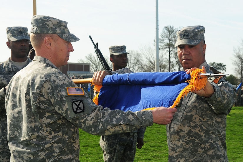 U.S. Army Col. Dean Heitkamp, left, 128th Aviation Brigade commander, and Maj. Gen. Anthony Crutchfield, Commanding General, United States Army Aviation Center of Excellence, furls the United States Army Aviation Logistics School guidon during the U.S. Army Aviation Logistics School Inactivation and 128th Aviation Brigade Activation Ceremony at Fort Eustis, Va., March 16, 2012The event was held to transition USAALS from a training school to a brigade. (U.S. Air Force photo by Staff Sgt. Ashley Hawkins/Released)