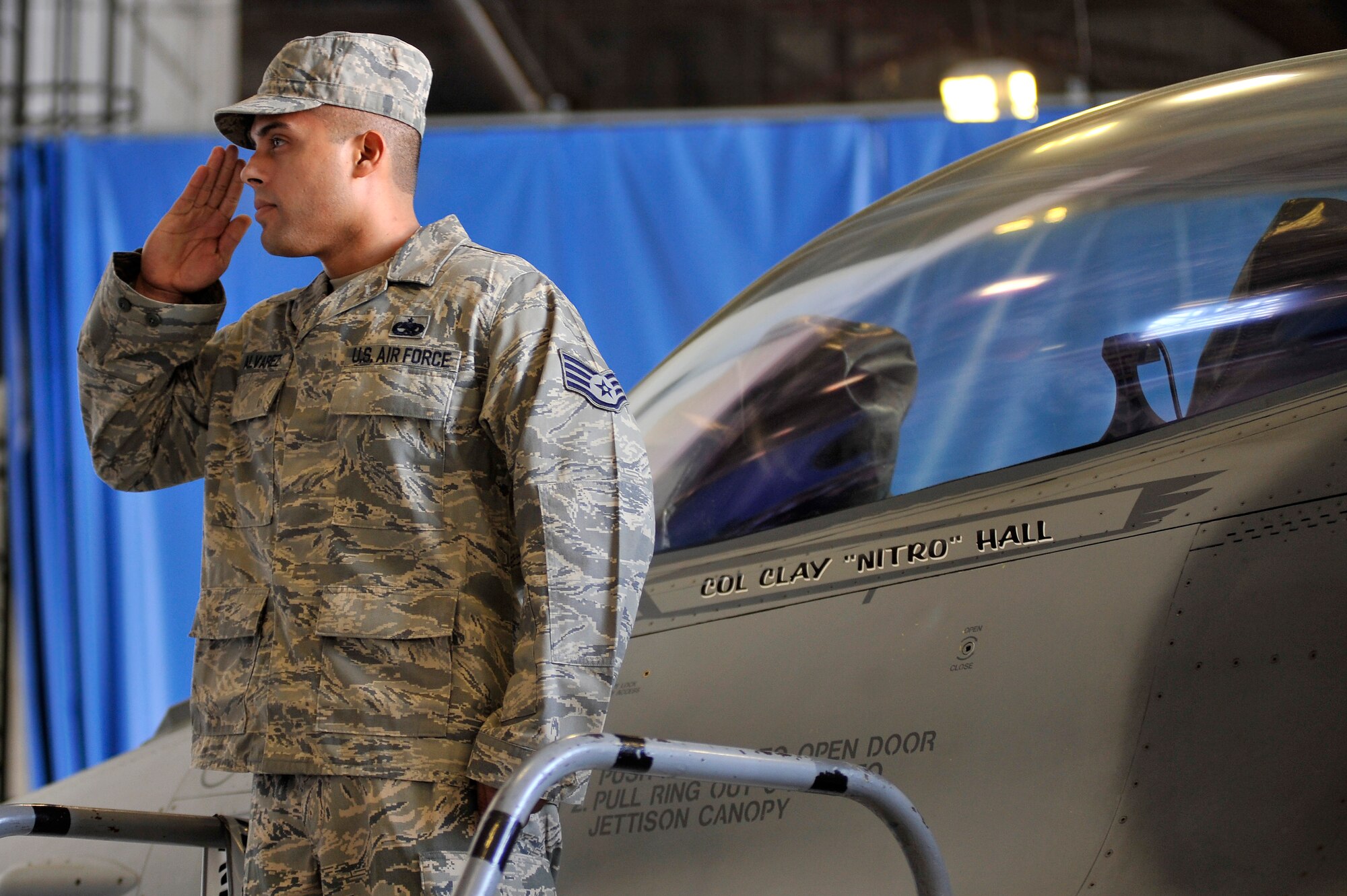 U.S. Air Force Staff Sgt. Victor Alvarez, 20th Aircraft Maintenance Squadron, salutes Col. Clay Hall, 20th Fighter Wing commander after unveiling Hall?s name displayed on the side of the 20th FW command F-16 Fighting Falcon during a change of command ceremony, March 19, 2012, Shaw Air Force Base, S.C. Hall took command from Col. Charlie Moore, who will proceed to his next assignment commanding the 57th Wing, Nellis Air Force Base, Nev. Prior to taking command of the 20th FW, Hall was serving as the 455th Expeditionary Operations Group commander at Bagram Air Base, Afghanistan. (U.S. Air Force photo by Senior Airman Kenny Holston/Released)

