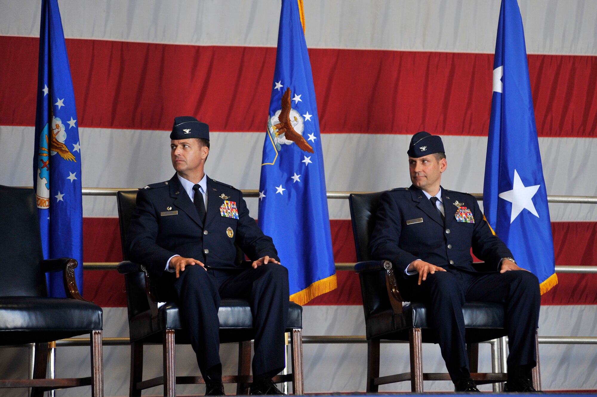 U.S. Air Force Col. Charlie Moore, (left) and Col. Clay Hall, listen to Maj. Gen. Lawrence Wells, 9th Air Force commander, during a change of command ceremony, March 19, 2012, Shaw Air Force Base, S.C. Hall took command from Col. Charlie Moore, who will proceed to his next assignment commanding the 57th Wing, Nellis Air Force Base, Nev. Prior to taking command of the 20th FW, Hall was serving as the 455th Expeditionary Operations Group commander at Bagram Air Base, Afghanistan. (U.S. Air Force photo by Senior Airman Kenny Holston/Released)

