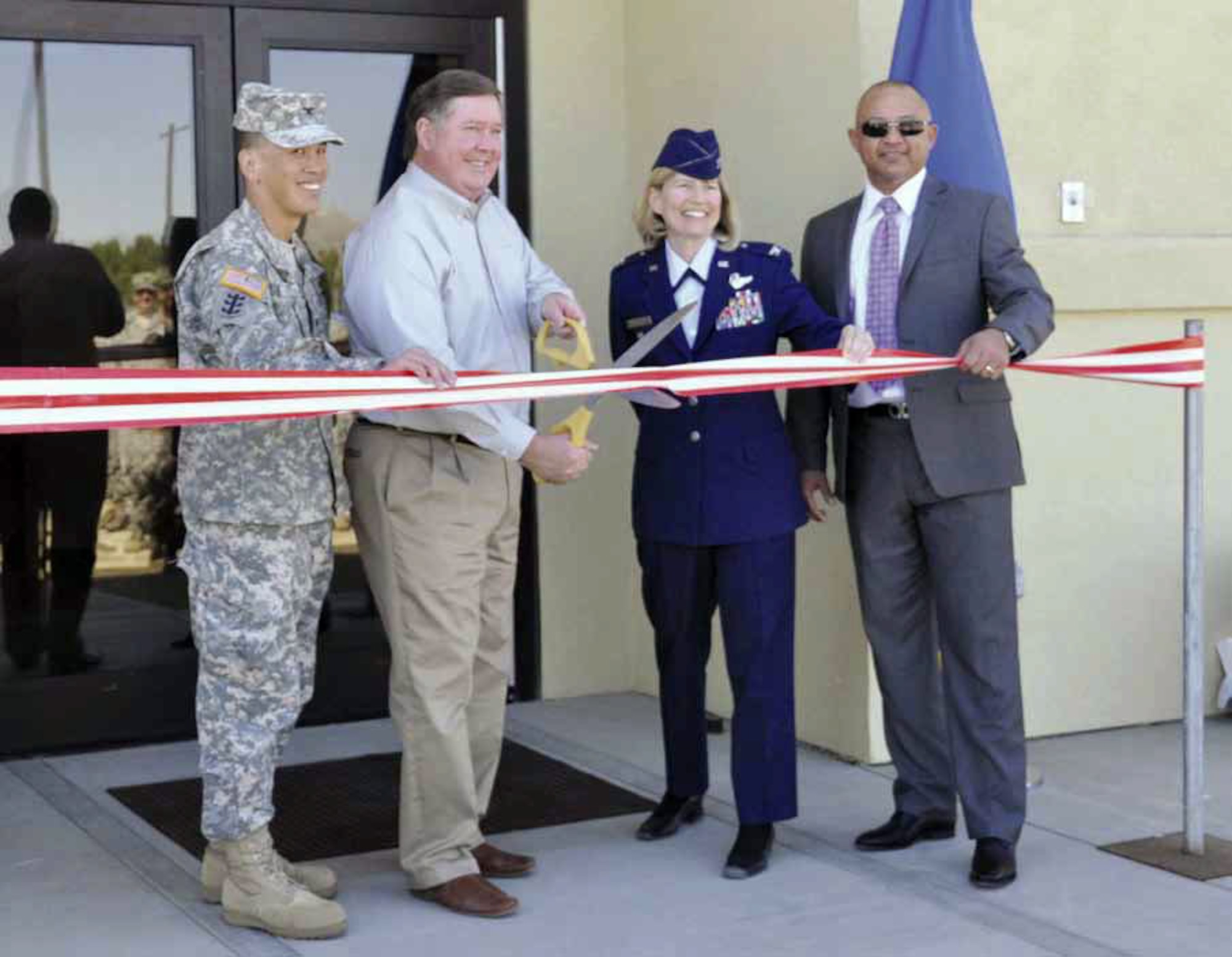 Col. Mark Toy, commander Los Angeles District, U.S. Army Corps of Engineers; Congressman Ken Calvert, 44th Congressional District; Col. Mary Aldrian, commander, 452d Air Mobility Wing and Hector Sanchez, president, P and S Construction, Inc., cut the ribbon to officially open the new Indoor Small Arms Training Range on March Air Reserve Base, Calif., March 10, 2012. The 28,000 square foot facility will have the capability to provide shooters both daytime and nighttime firing options and will be open for business sometime in April. (U.S. Air Force photo TSgt Joe Davidson)