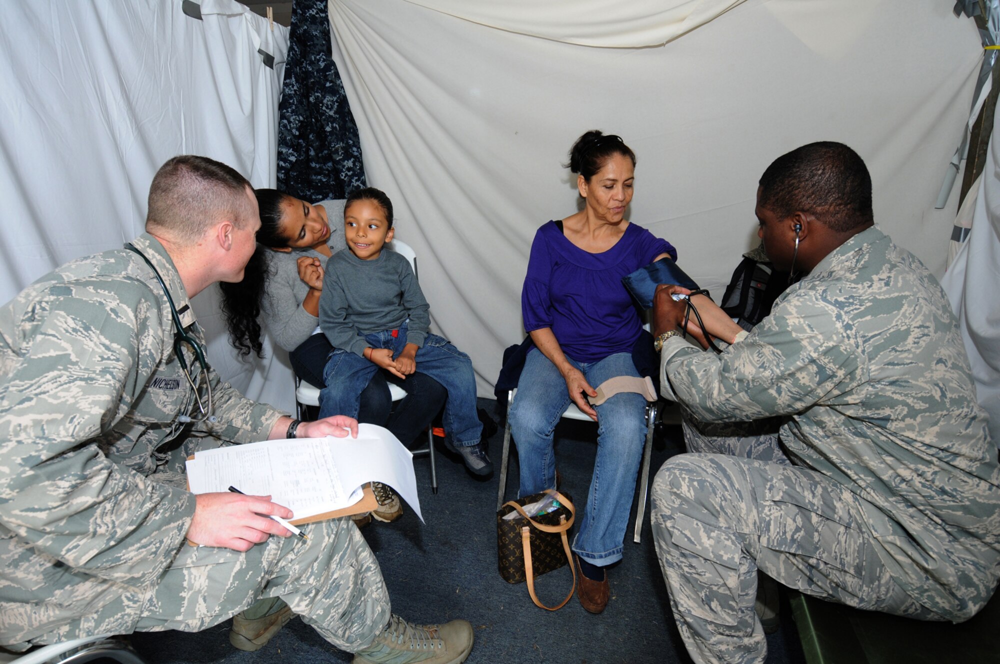 1Lt. Brock Nicholson,110 Medical Group and 2Lt Orlando Bromell, 192 Medical Group,  provide medical care to a Hawaiin resident as part of Tropic Care Innovative Readiness Training on March 6. Tropic Care Innovative Readiness Training is comprised of military personnel assets of the U.S. Armed Forces to include Active Duty, Reserve and National Guard members who provide free medical services and conduct deployment and readiness training while forward deployed to the medically underserved island of Kaua'i, Hawaii from February 26 through March 10.  (National Guard photo by Tech. Sgt. Melissa E. Chatham) (released)