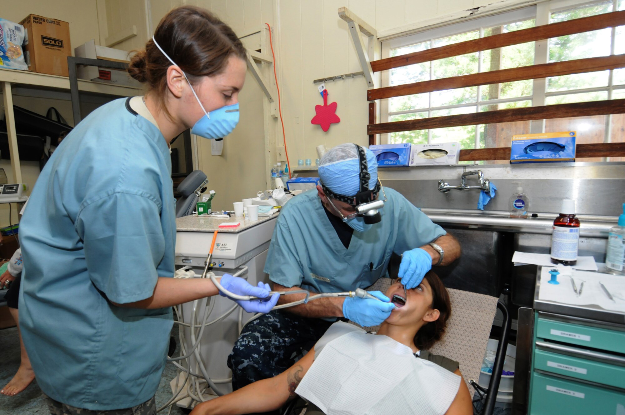 Capt. Anthony Batko, Operational Hospital Support Unit, Bethesda, Maryland  and Senior Airman Amanda Bean, 110 Medical Group, Michigan Air National Guard provides dental care to a Hawaiin resident as part of Tropic Care Innovative Readiness Training on March 6. Tropic Care Innovative Readiness Training is comprised of military personnel assets of the U.S. Armed Forces to include Active Duty, Reserve and National Guard members who provide free medical services and conduct deployment and readiness training while forward deployed to the medically underserved island of Kaua'i, Hawaii from February 26 through March 10.  (National Guard photo by Tech. Sgt. Melissa E. Chatham) (released) 