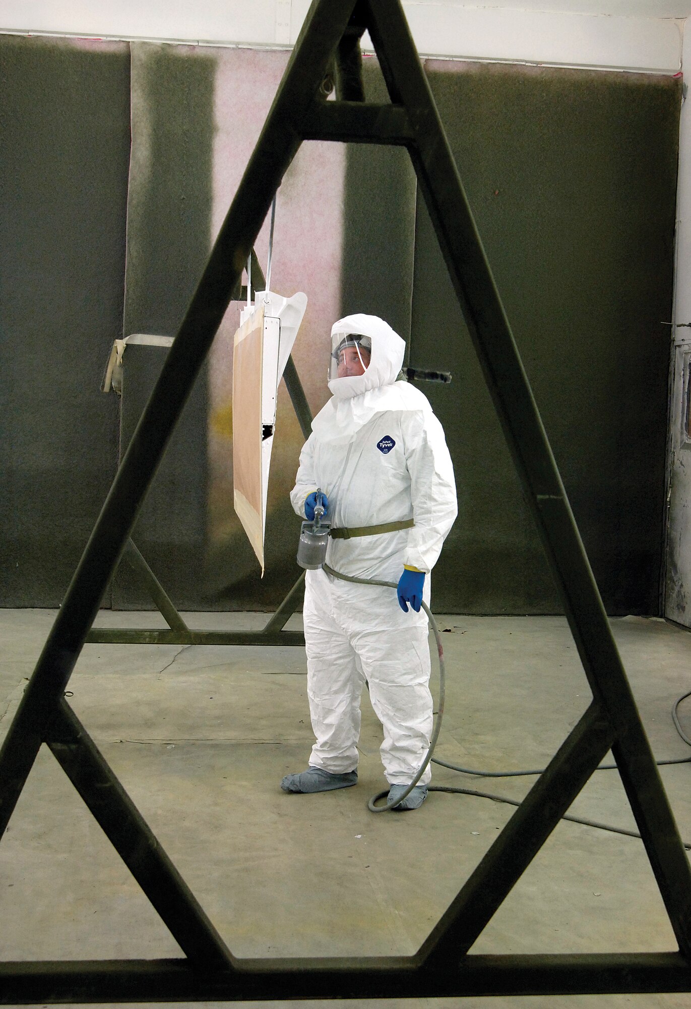 John Teas, a 551st Commodities Maintenance Squadron painter, surveys a newly-painted B-1 spoiler in a shop paint booth located in Bldg. 9001.  Workers have streamlined their processes so effectively with a new modular work flow design that turnaround times on parts is a fourth what it was and they crank out almost double what they previously did. (Air Force photos by Margo Wright)