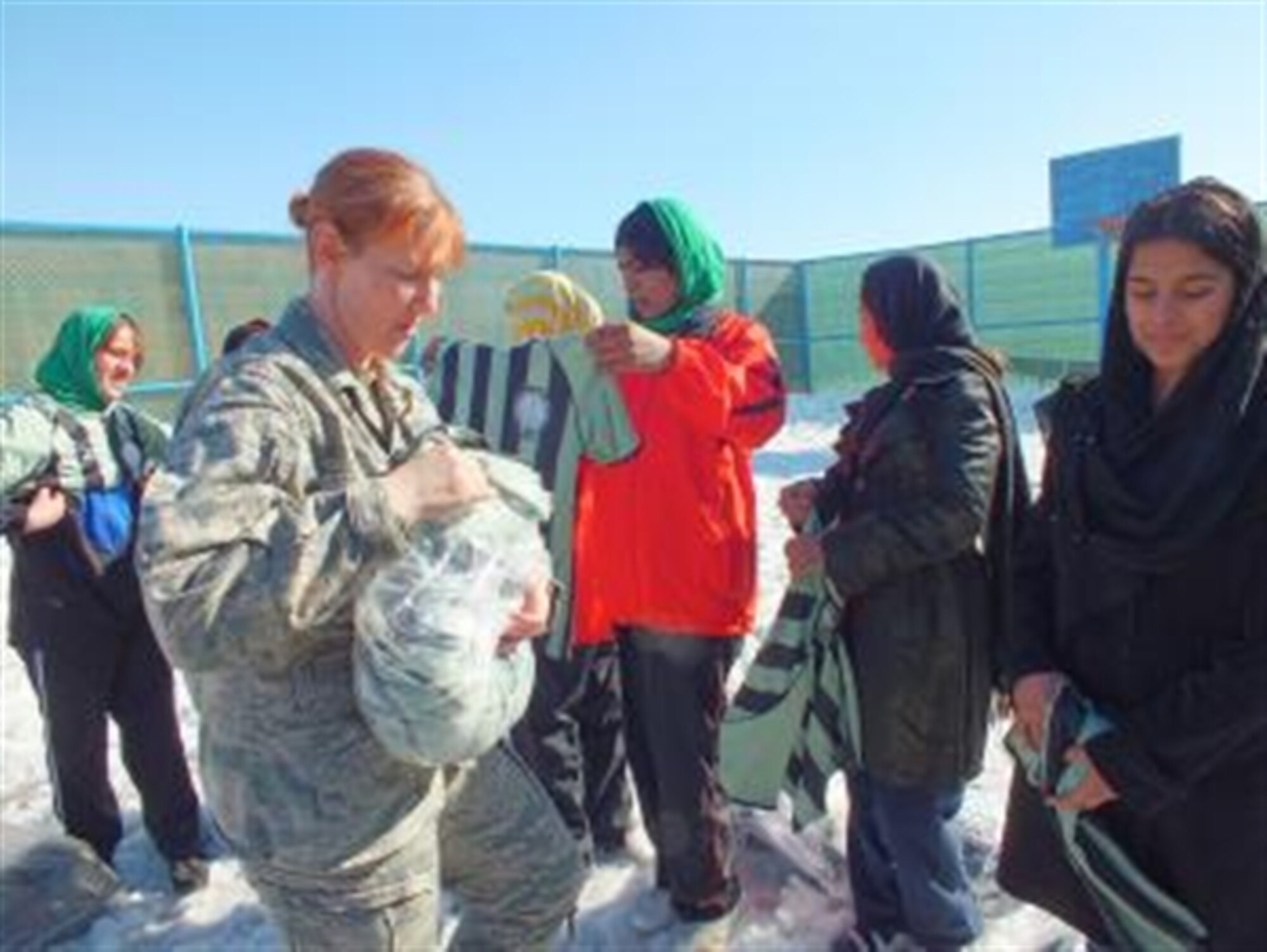U.S. Air Force Col. AnneMarie Fenton hands out soccer jerseys to soccer players at the Allahuddin Orphanage in Kabul, Afghanistan, Feb. 29, 2012. With help from her daughter in Burke, Va., Fenton helped to coordinate the donation of more than 1,100 items to distribute to Afghan girls soccer teams. (U.S. Army photo/Sgt. April Campbell)