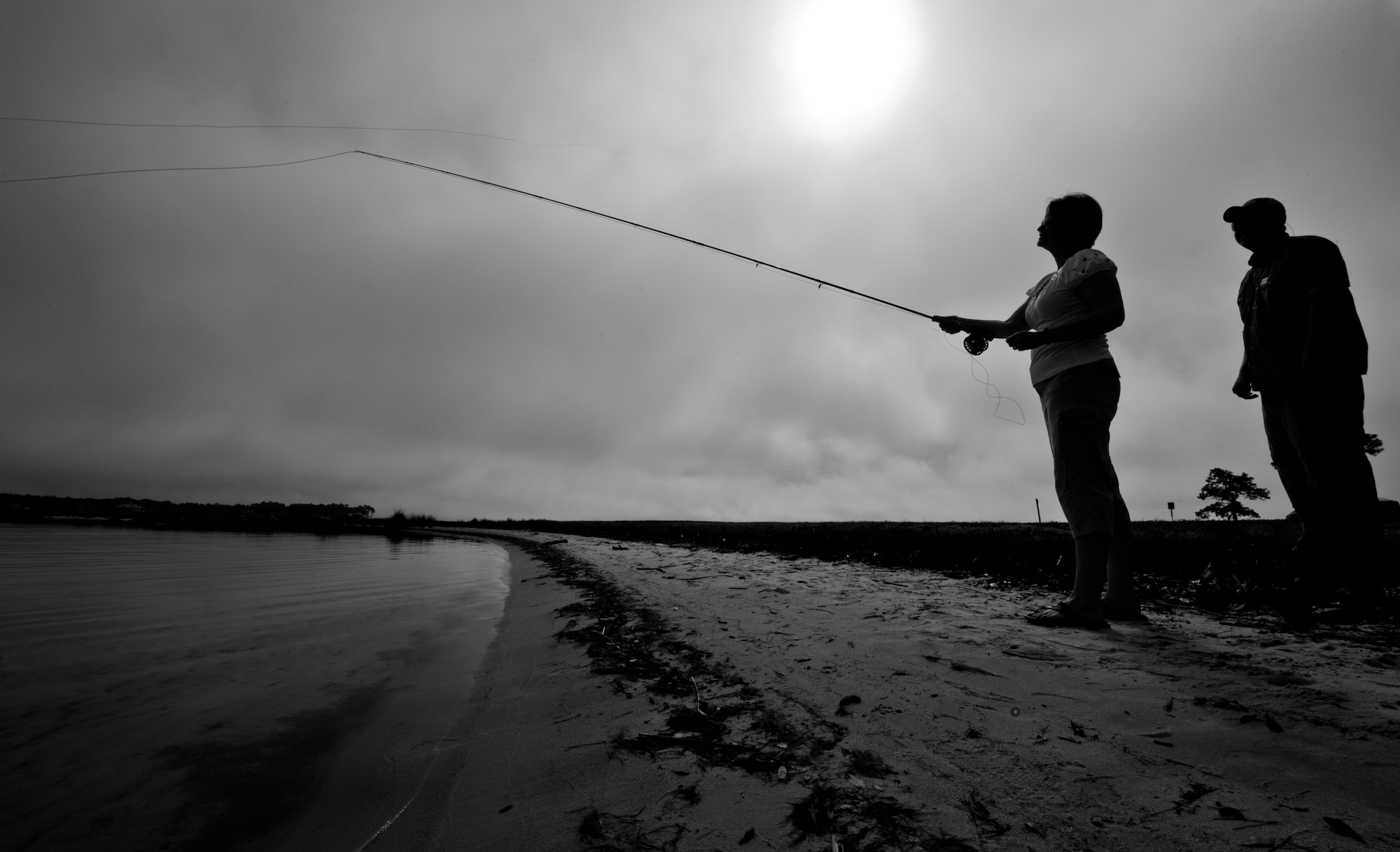 Mariann Rosenquest perfects her cast while James Smith, an Orvis fishing instructor, watches during a Fly Fishing 101 class held at Eglin Air Force Base, Fla., March 17.  Participants were instructed on how to tie lures and hooks and how to cast with the fly fishing rod during the three-hour class.  Outdoor Recreation hosts two more classes April 21 and May 19 from 9 a.m. to noon.  For more information or to sign up, call 882-5058. (U.S. Air Force photo/Samuel King Jr.)
