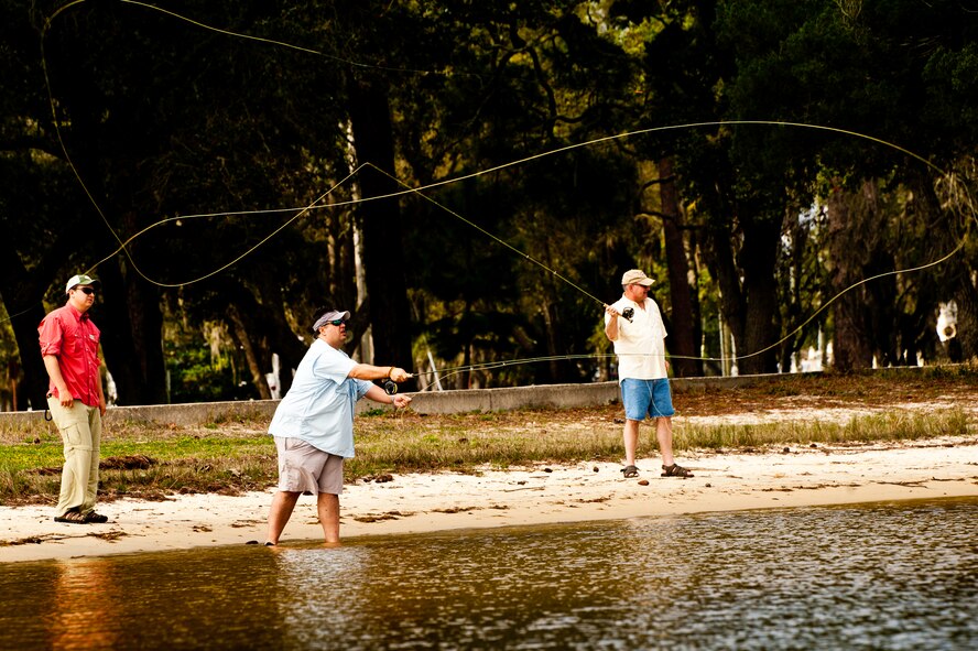 James Smith, an Orvis fishing instructor, watches as Lee Murphy and Mark Hayes practice fly-fish casting during a Fly Fishing 101 class at Eglin Air Force Base, Fla., March 17.  Participants were instructed on how to tie lures and hooks and how to cast with the fly fishing rod during the three-hour class.  Outdoor Recreation hosts two more classes April 21 and May 19 from 9 a.m. to noon.  For more information or to sign up, call 882-5058.  (U.S. Air Force photo/Samuel King Jr.)