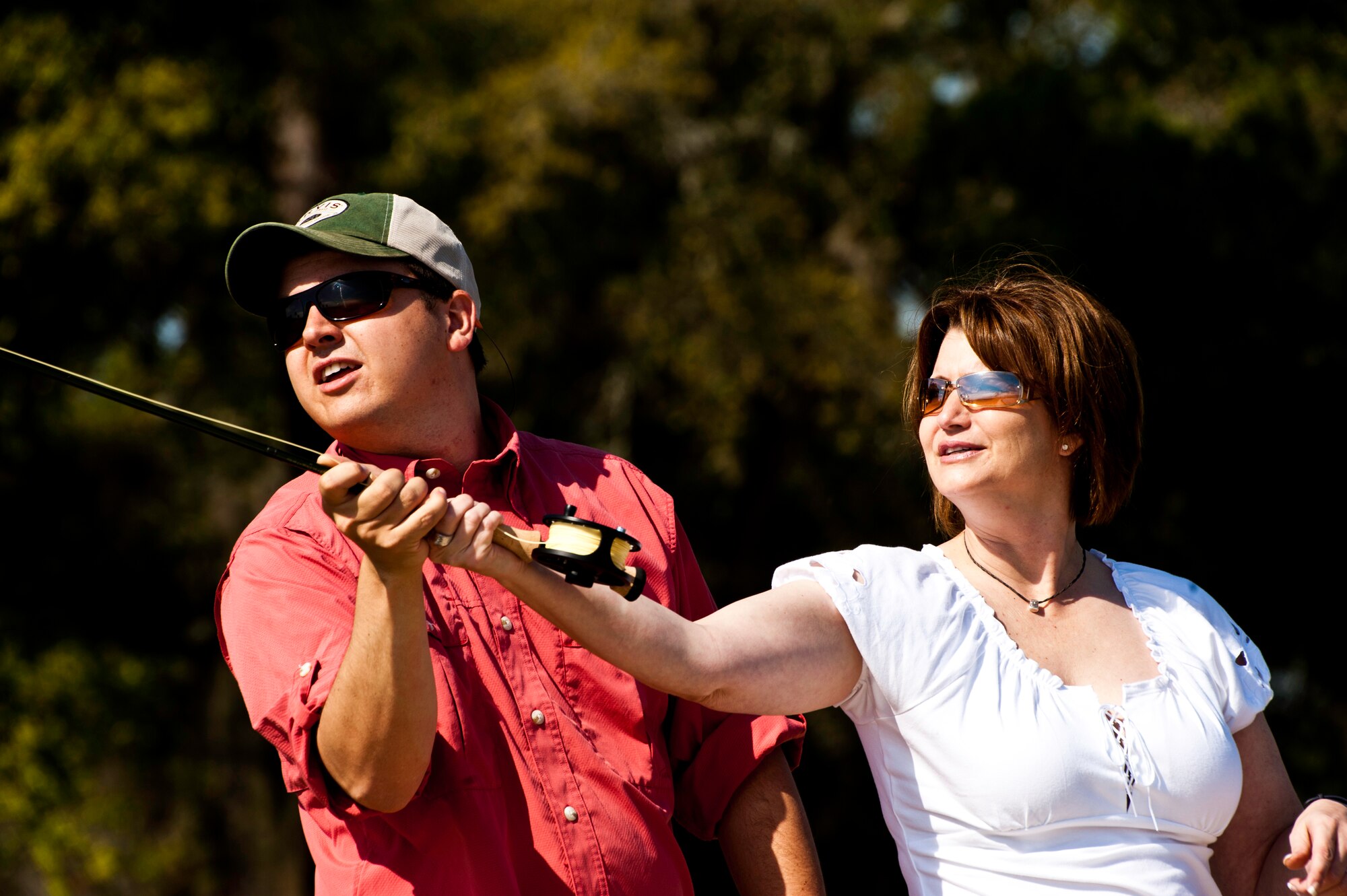 James Smith, an Orvis fishing instructor, helps Mariann Rosenquest perfect her cast during a Fly Fishing 101 class held at Eglin Air Force Base, Fla., March 17.  Participants were instructed on how to tie lures and hooks and how to cast with the fly fishing rod during the three-hour class.  Outdoor Recreation hosts two more classes April 21 and May 19 from 9 a.m. to noon.  For more information or to sign up, call 882-5058. (U.S. Air Force photo/Samuel King Jr.)