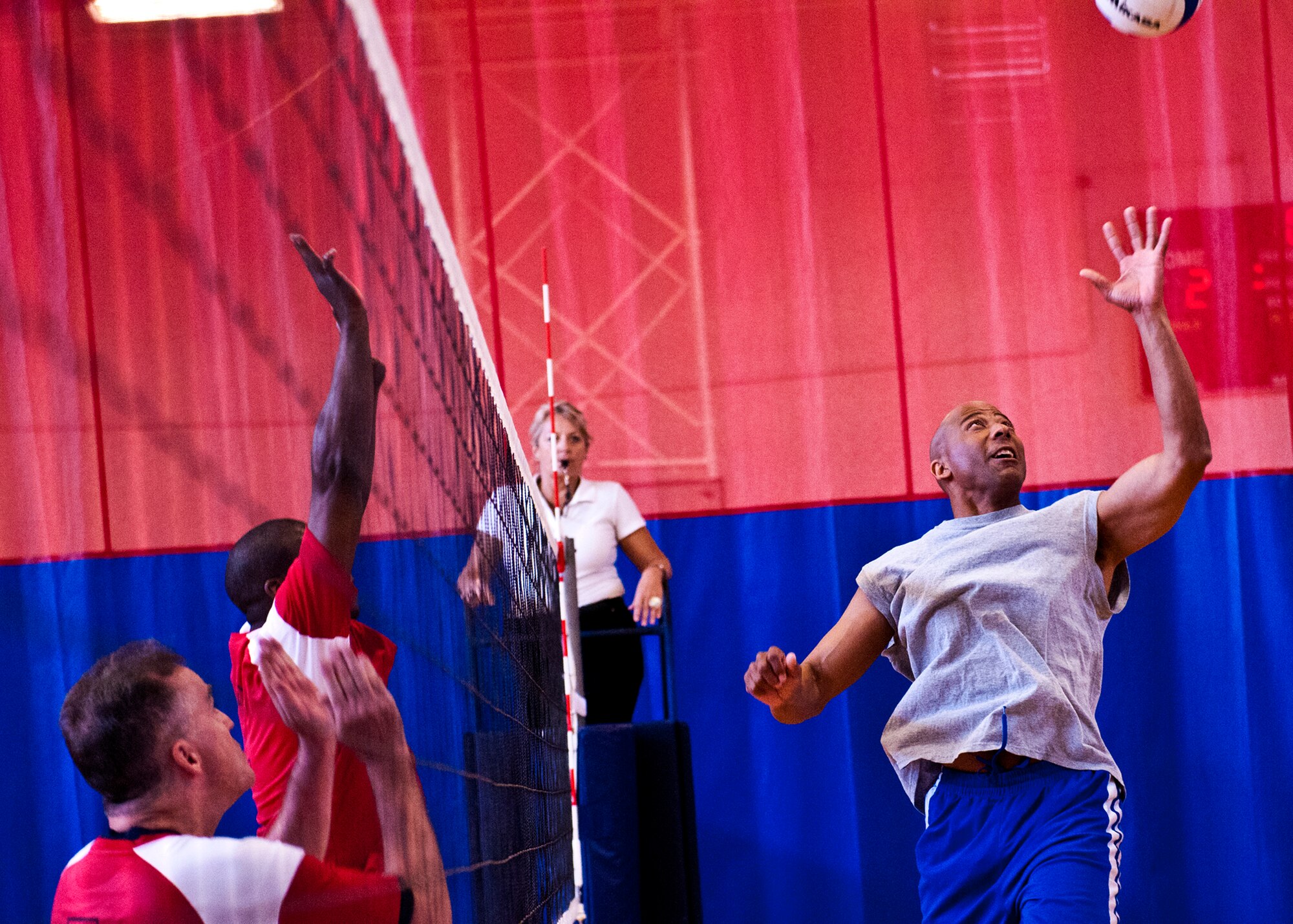 Tony Douglas reaches for the ball at the net during the Eagles versus Chiefs volleyball game March 16 at Eglin Air Force Base, Fla.  The Eagles took the win in the second of three volleyball games pitting officers and enlisted Airmen.  The officers swept all three games with the Commanders and the Company Grade Officers Council also winning.  (U.S. Air Force photo/Samuel King Jr.)