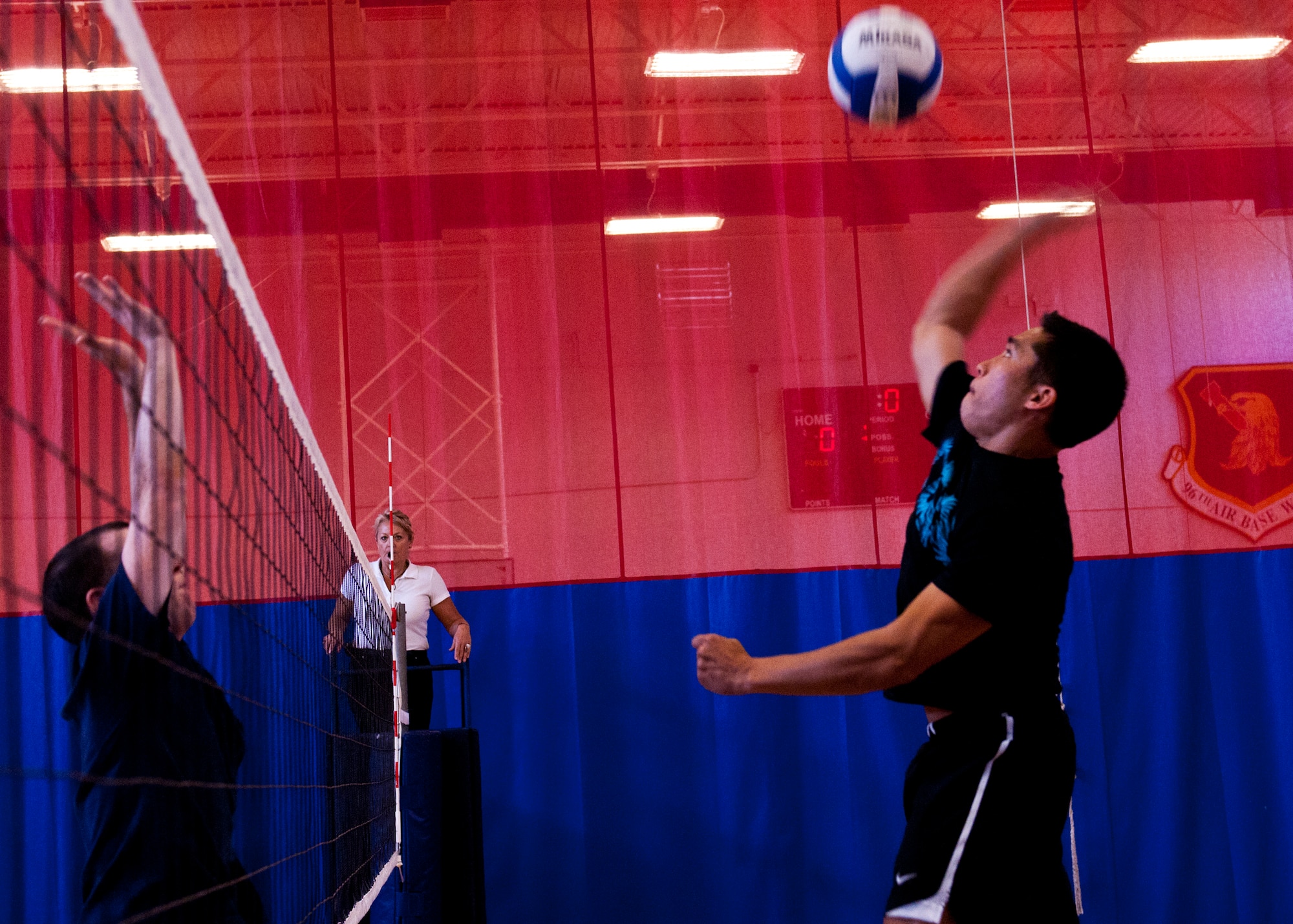 Christopher Toves goes up for a spike during the Company Grade Officers Council versus 5/6 NCO Council volleyball game March 16 at Eglin Air Force Base, Fla.  The CGOC took the win in the first of three volleyball games pitting officers and enlisted Airmen.  The officers swept all three games with the Commanders and the Eagles also winning.  (U.S. Air Force photo/Samuel King Jr.)