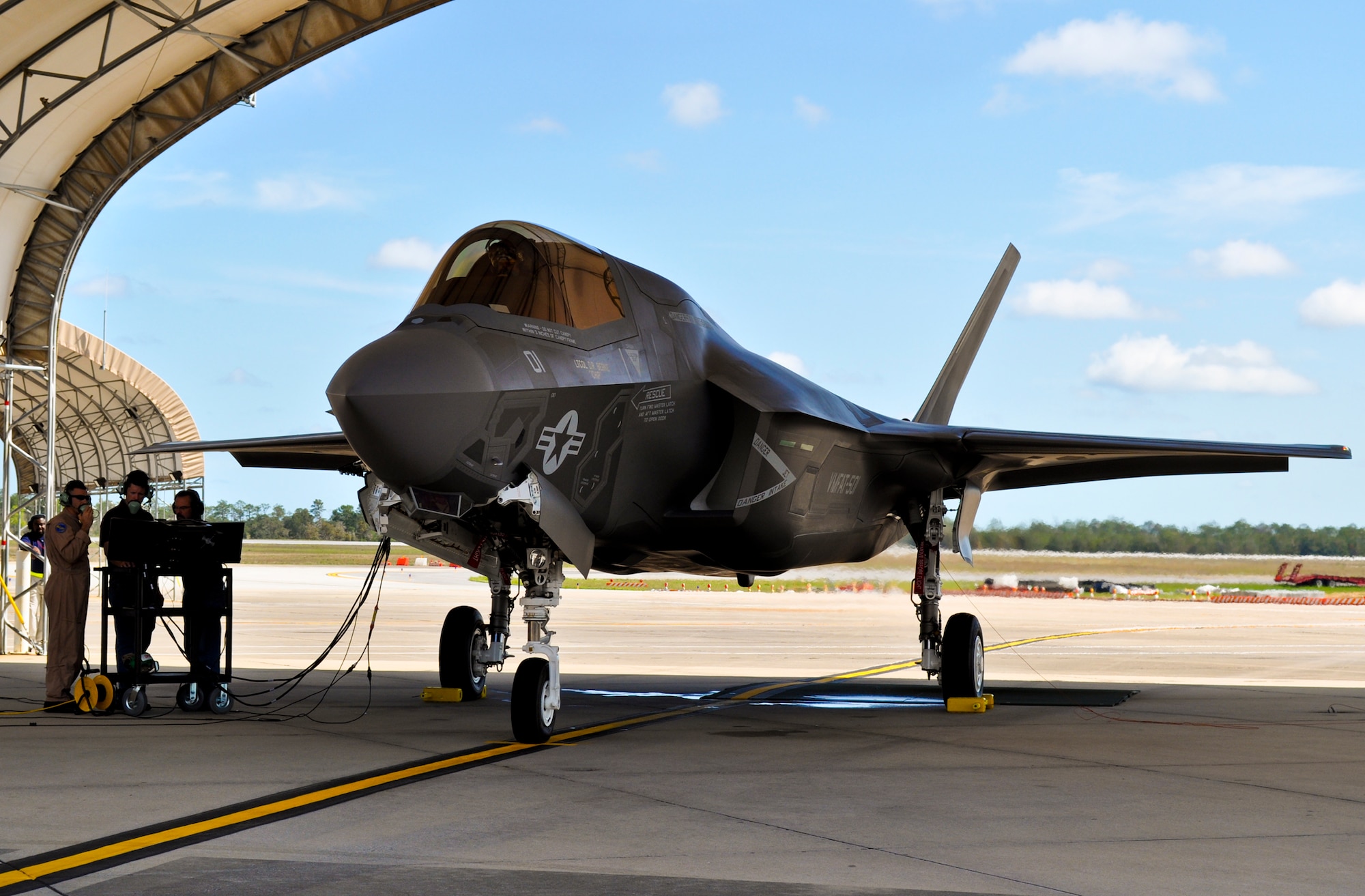 Maj. Aric Liberman, the operations officer for the Marine Fighter Attack Squadron 501, and Lockheed Martin personnel train during the first engine run of the F-35B Lightning II joint strike fighter at Eglin Air Force Base, Fla., March 14.  The run determines the joint strike fighter's health and is the first step in moving toward F-35B flights here. (U.S. Air Force photo/Maj. Karen Roganov)